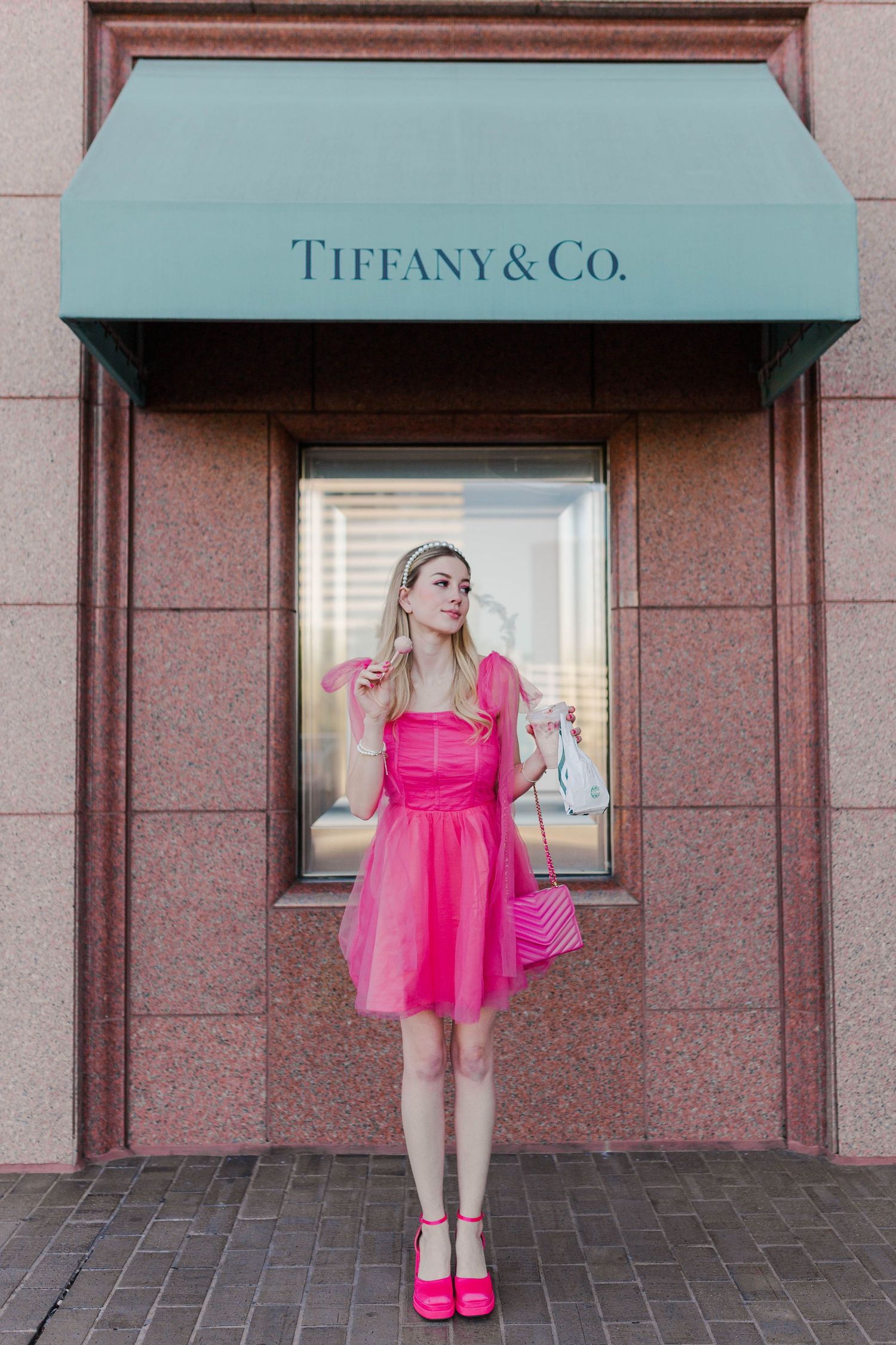 blonde model in hot pink dress and heels in front of Tiffany & Co at the Galleria in Houston, Texas for a barbie themed photoshoot