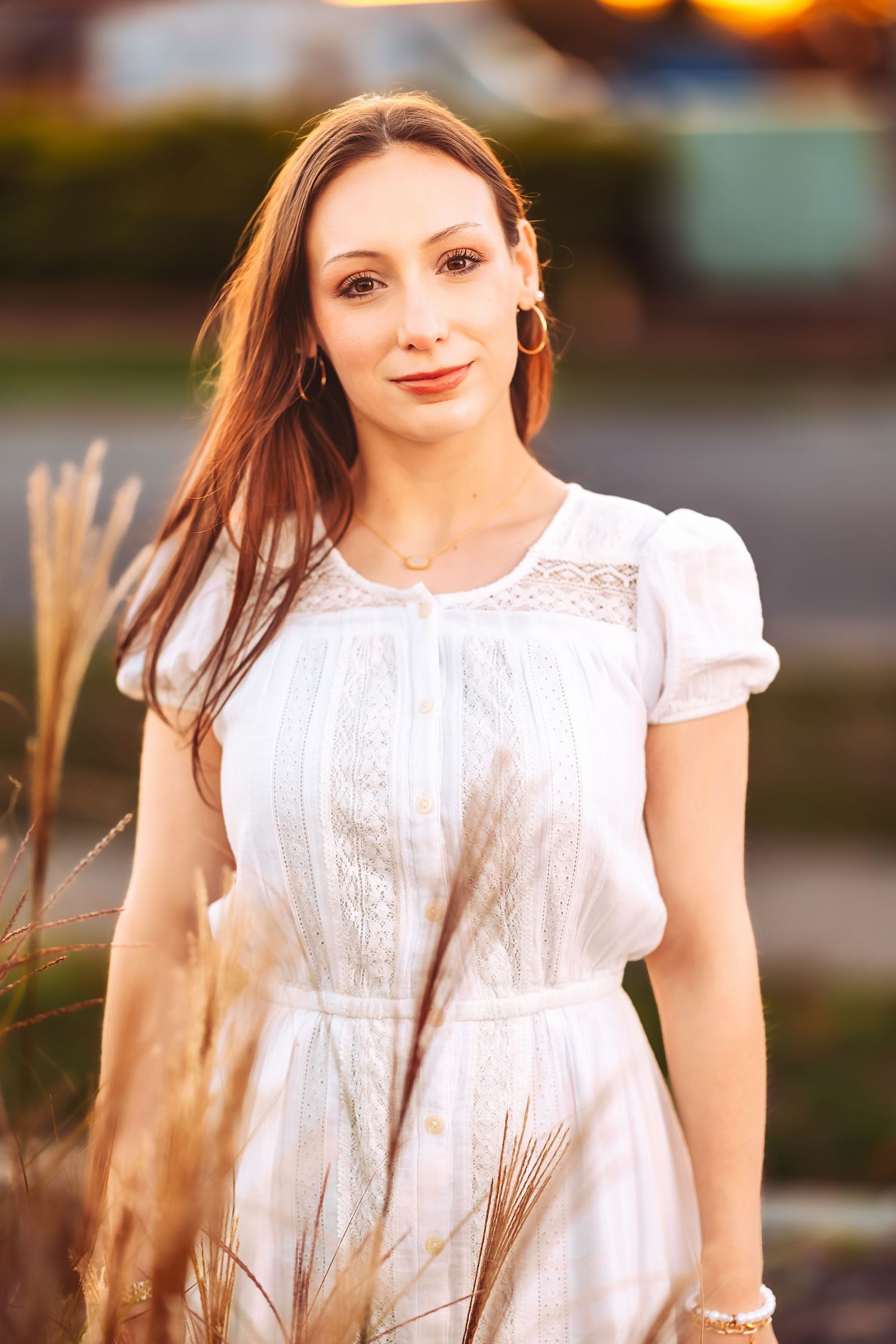 Ethereal portrait series in a white lace dress with soft natural lighting and wheat field backdrop.