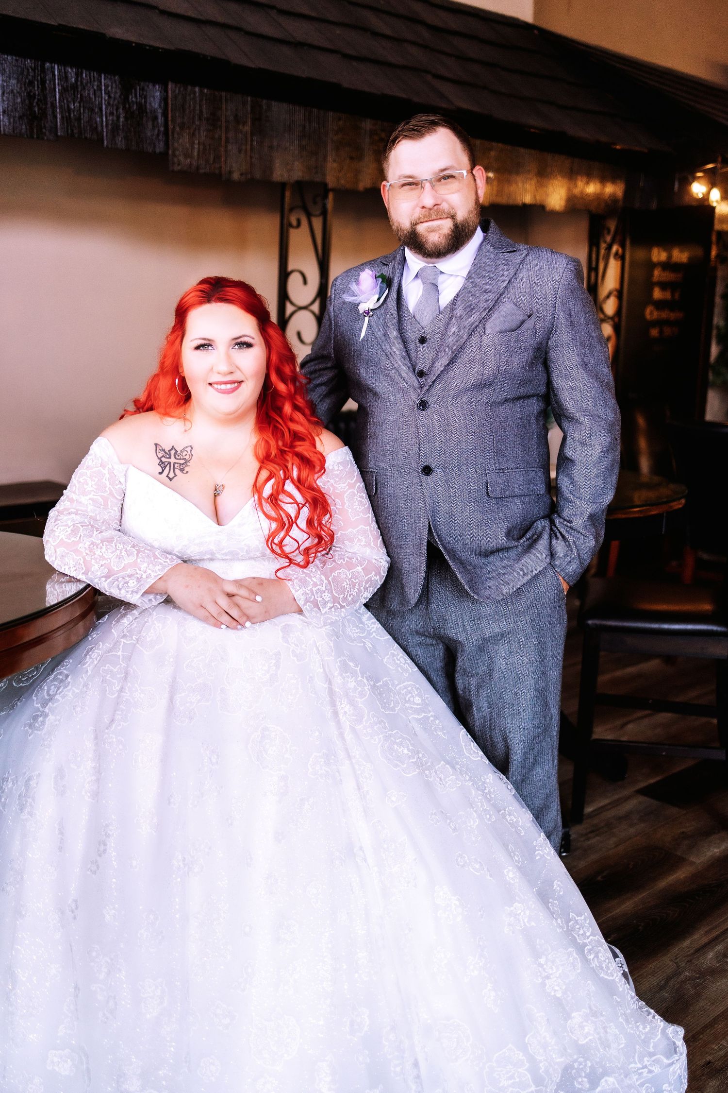 Wedding portraits showcasing couple in white lace gown and grey suit against urban backdrop.