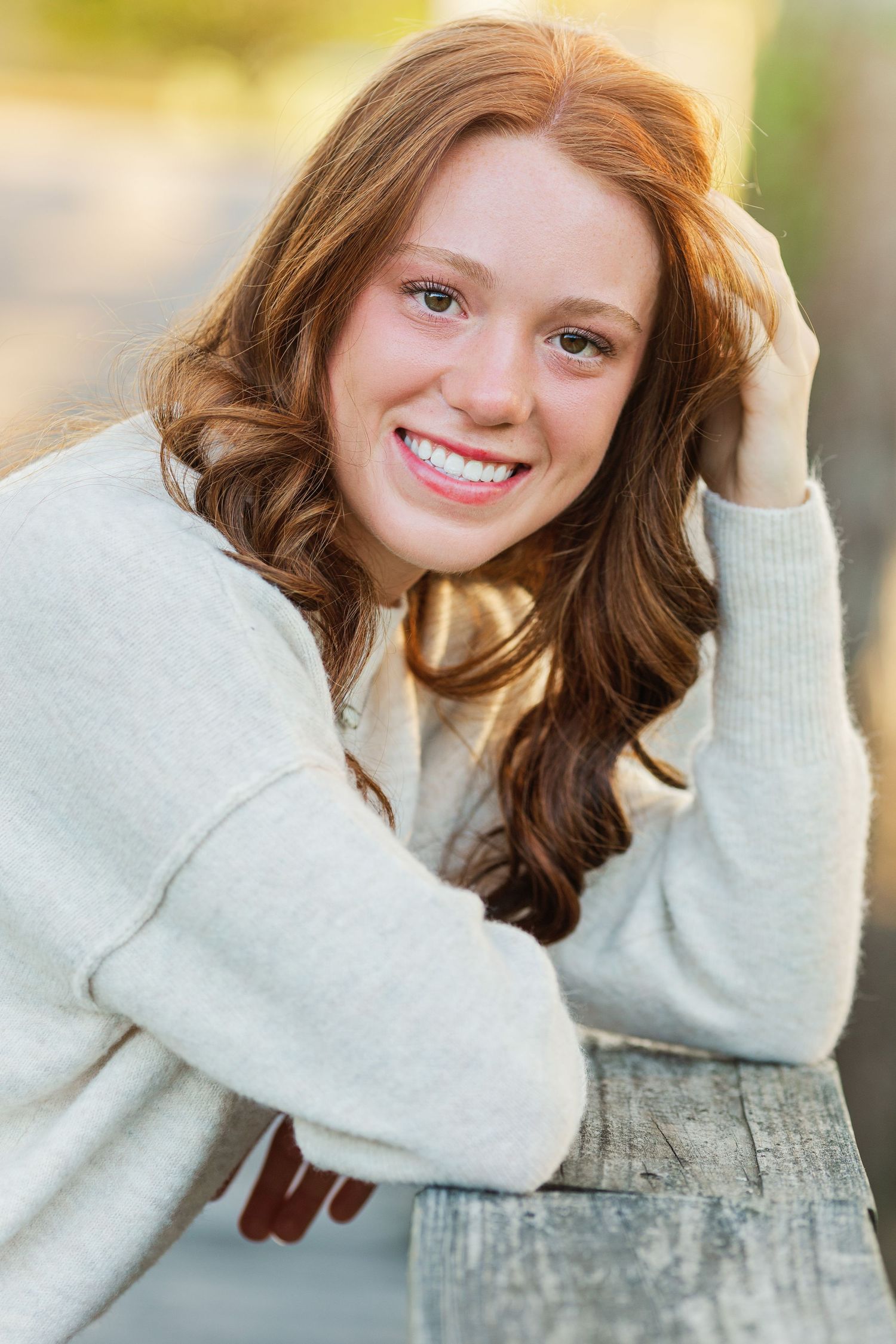 Portrait series showing someone in cozy white sweater against neutral background.