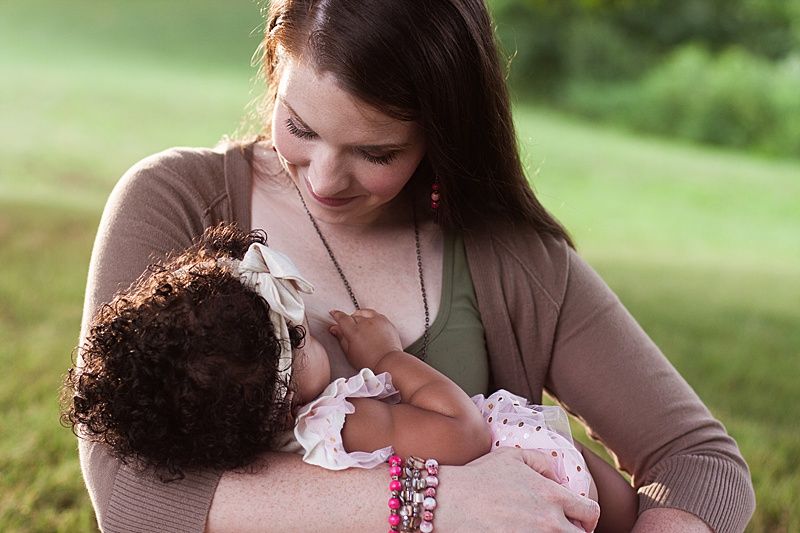 Quiet nursing moment captured in a serene outdoor environment.