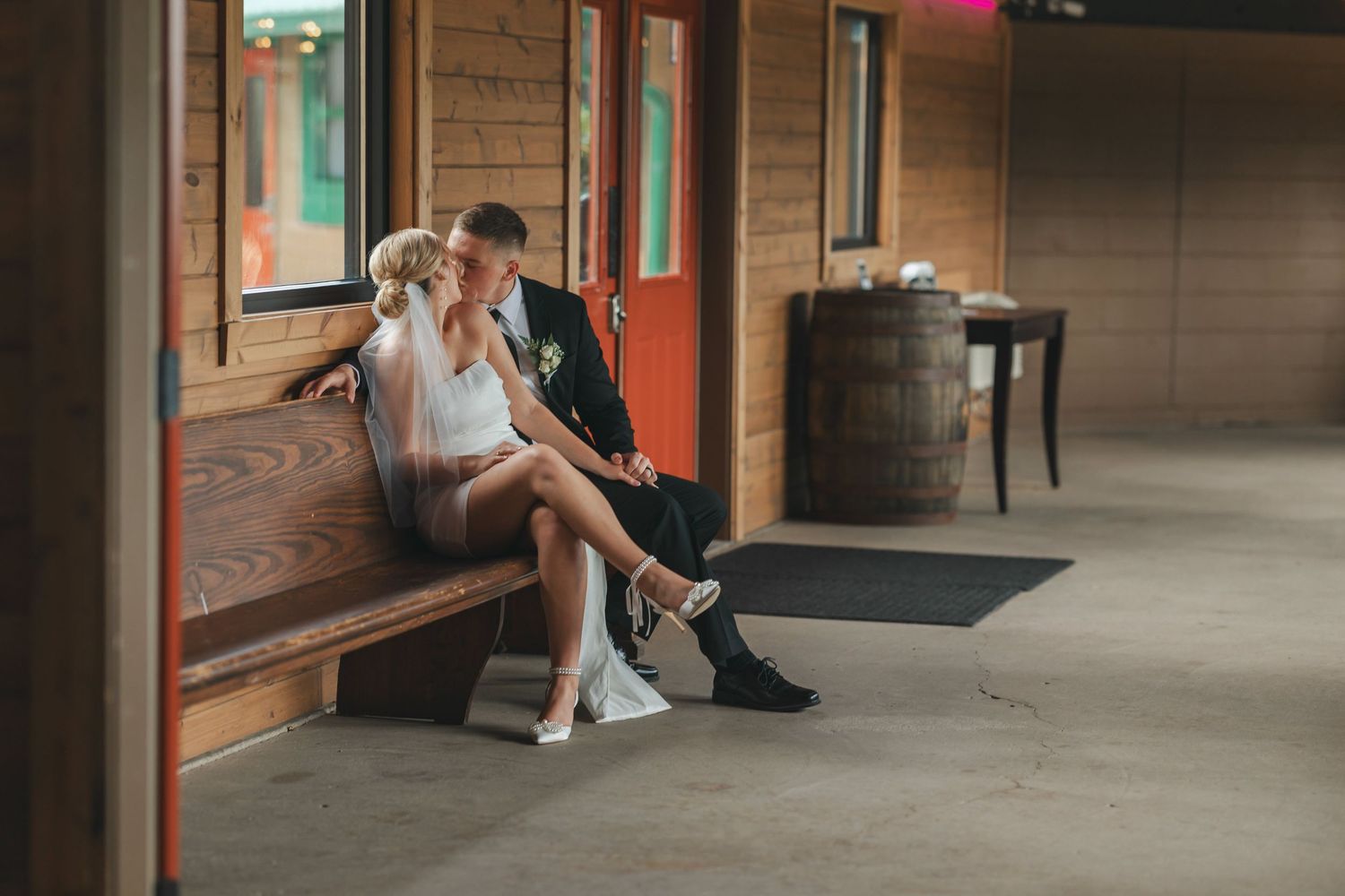 Couple sitting together in a rustic wooden interior with natural lighting.