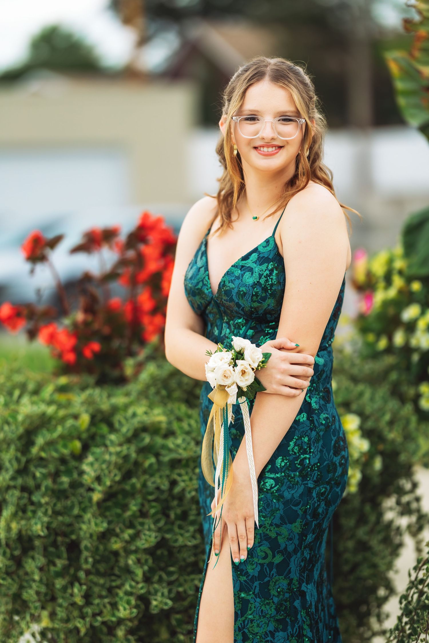 Portrait series in garden setting featuring emerald green formal dress.