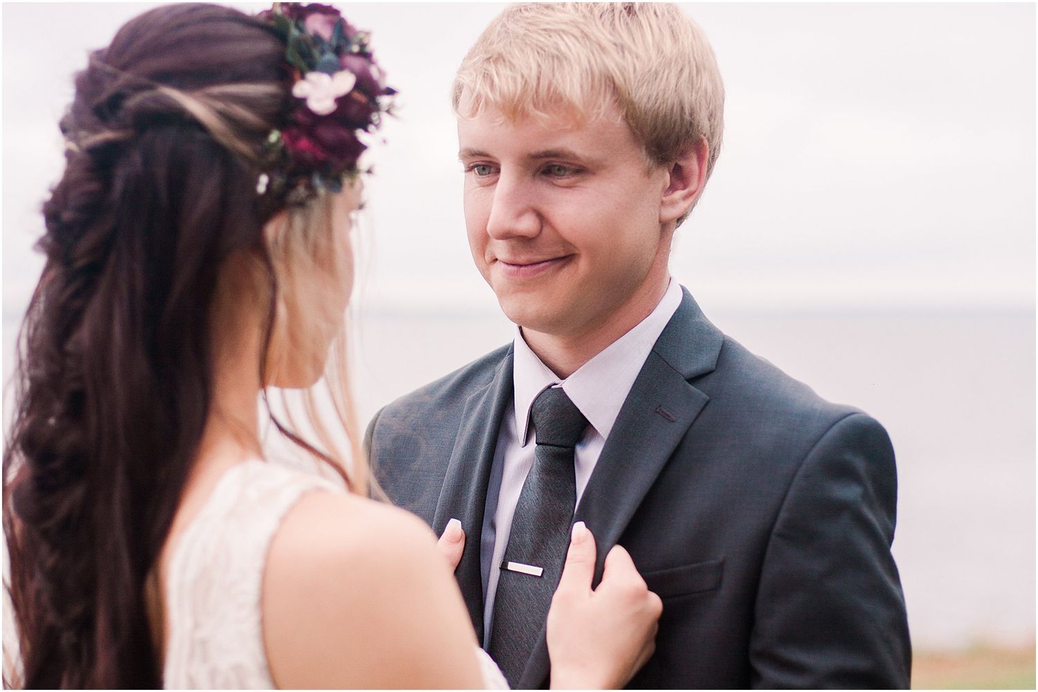Close up of tender moment between couple during outdoor wedding portraits.