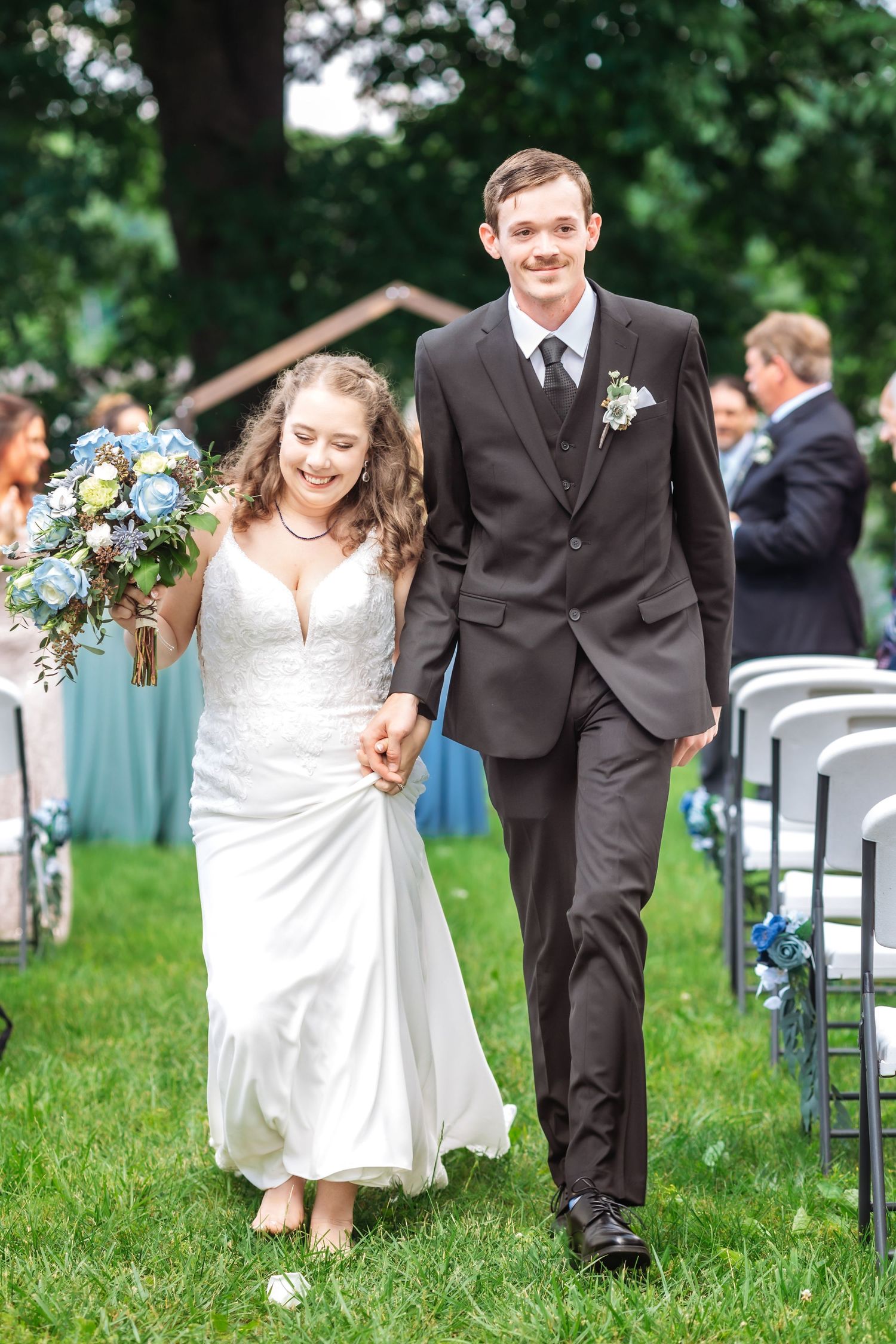 Wedding ceremony sequence showing a couple walking together on lush green grass.
