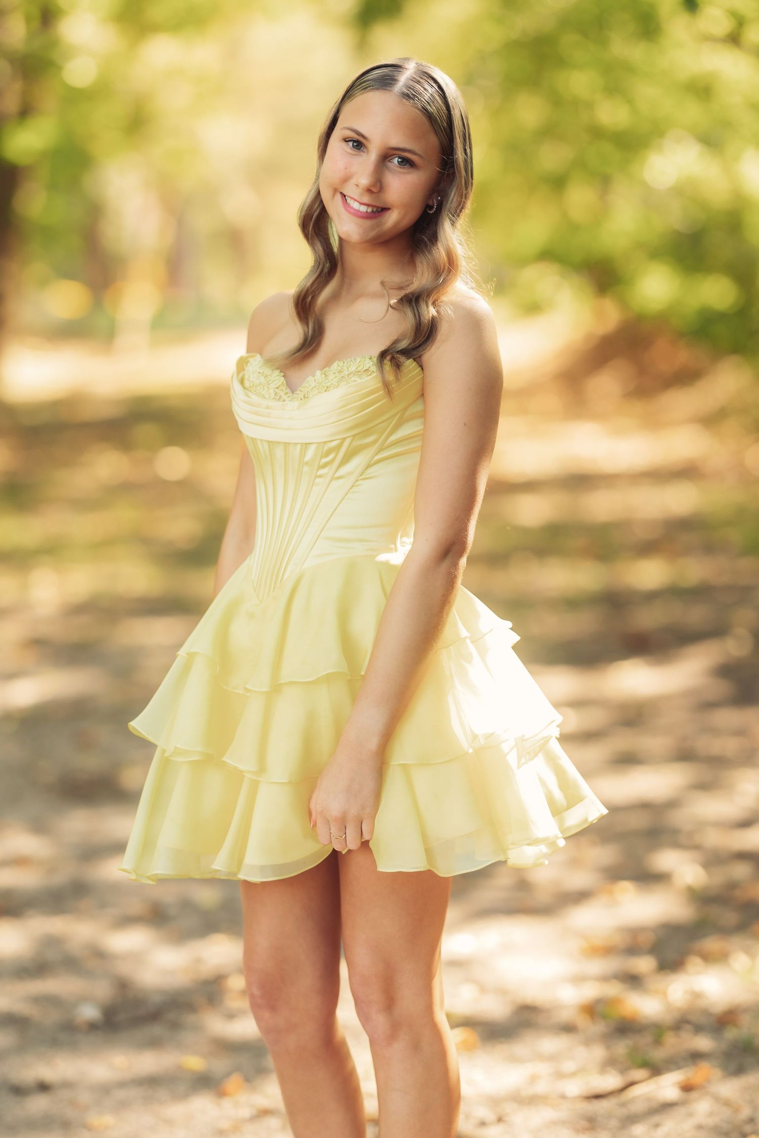 Yellow ruffled dress photographed in natural outdoor lighting.