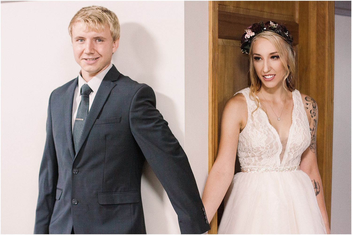 A couple sharing their first look before their wedding through a doorway.