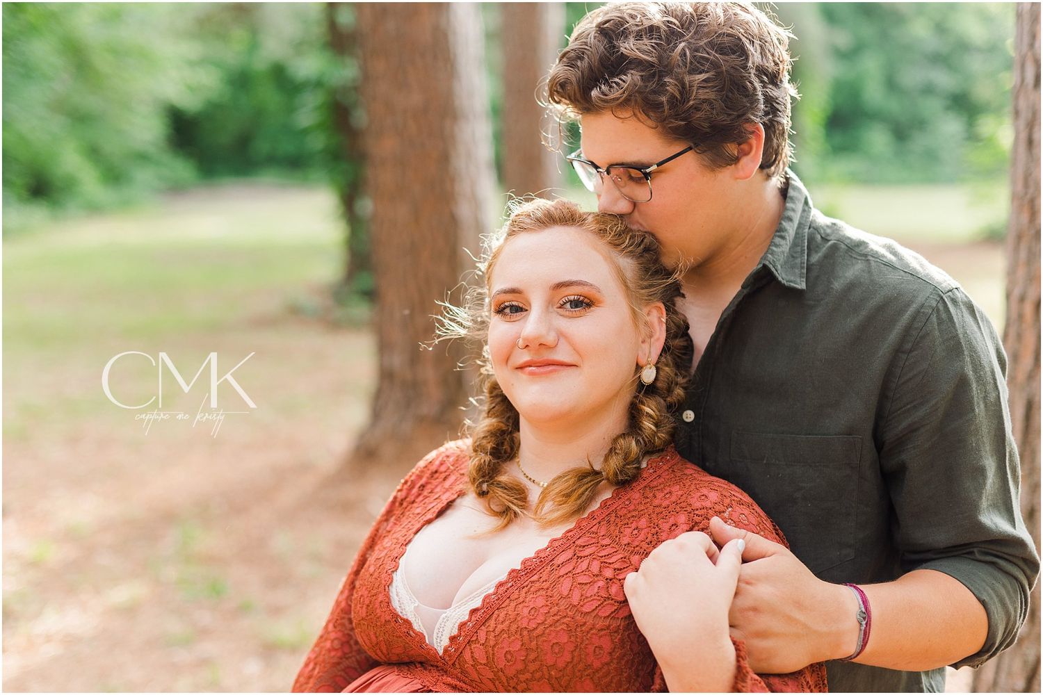 Intimate maternity portrait in forest with couple in rustic autumn attire.