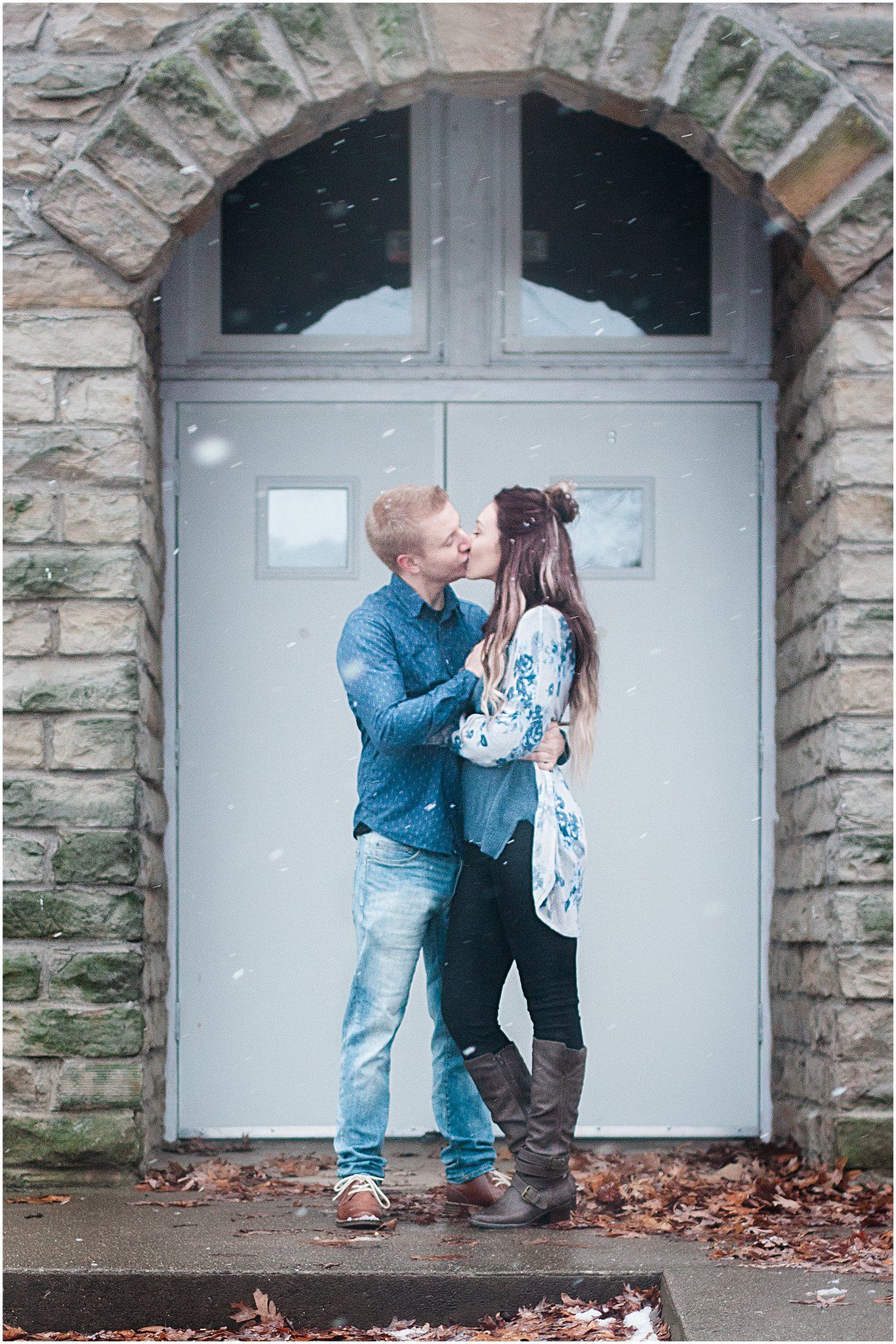 A romantic portrait under a stone archway features a couple in casual winter attire.
