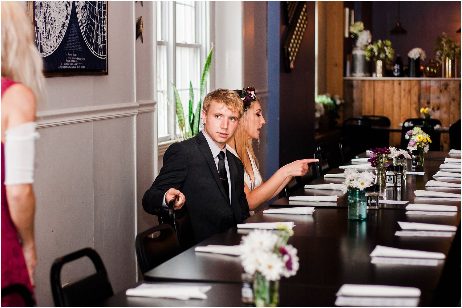 A long dining table set with place settings and floral centerpieces in an elegant room.