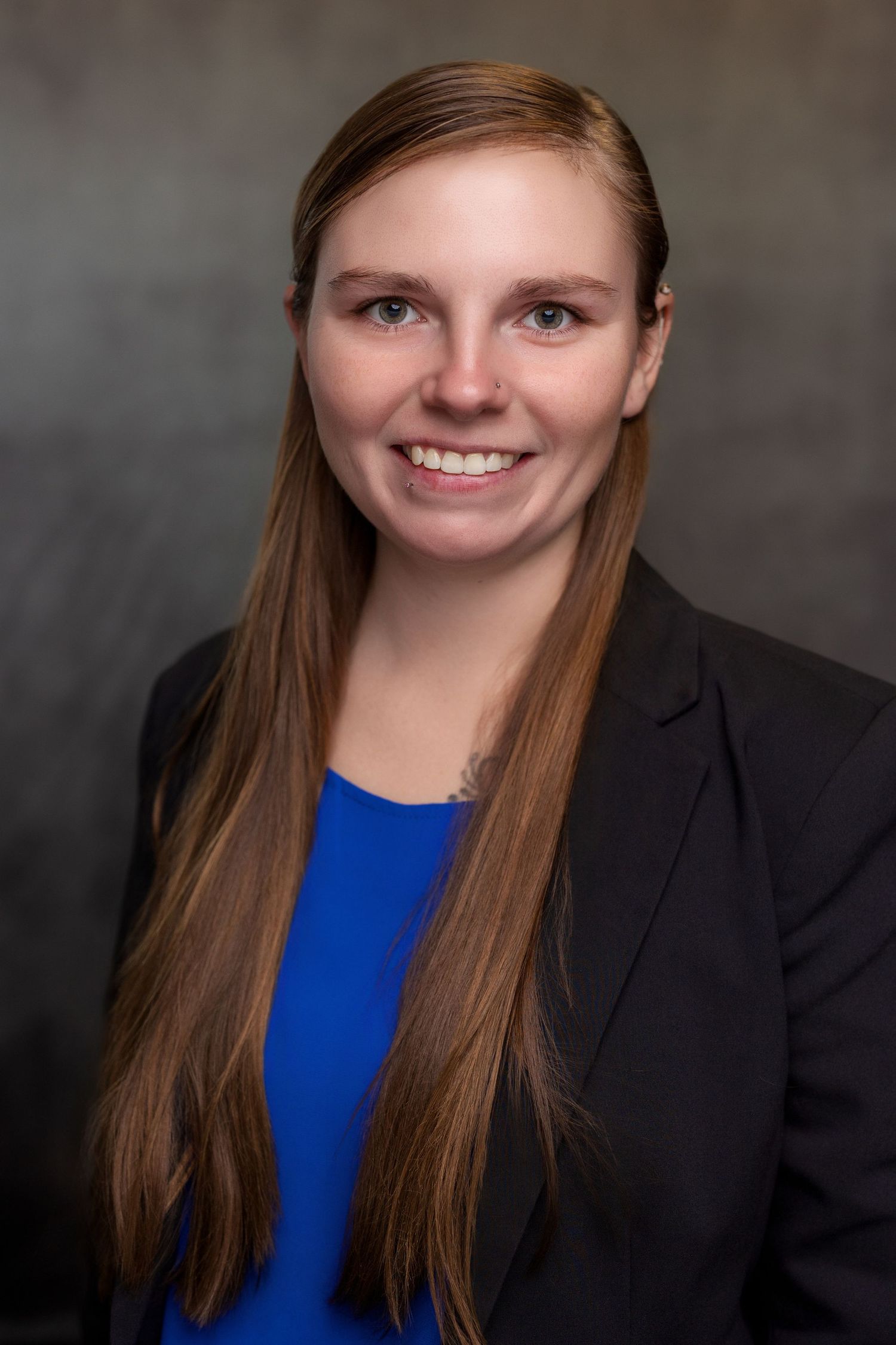 Professional headshot sequence showing person in blue top and black blazer against neutral backdrop.