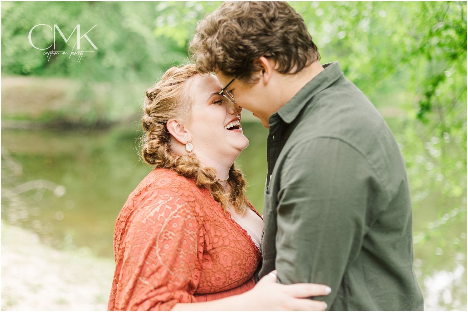 A joyful outdoor portrait capturing a couple sharing a laugh during their photoshoot.