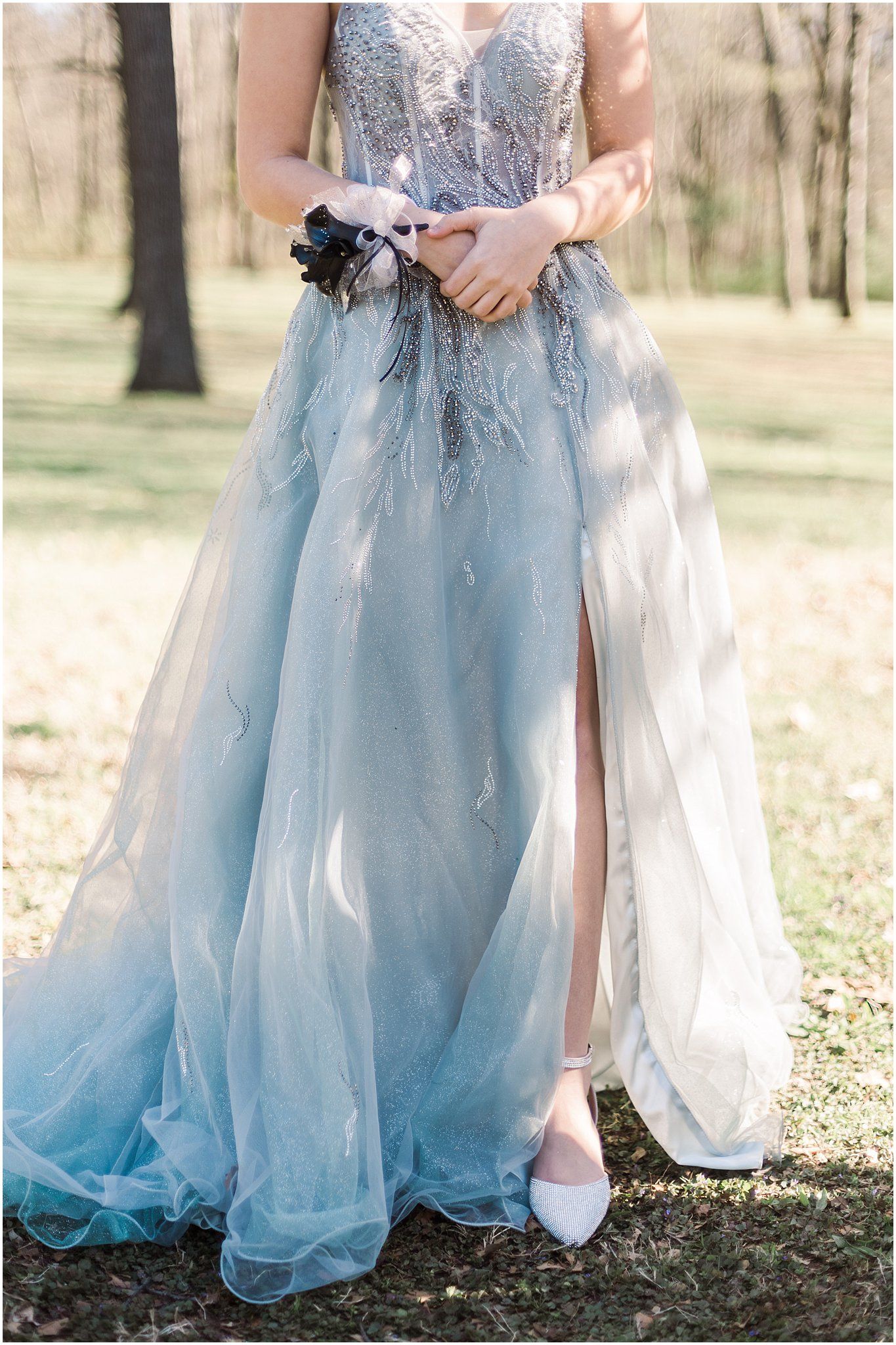 Light blue tulle gown with beaded bodice and flowing skirt detail.