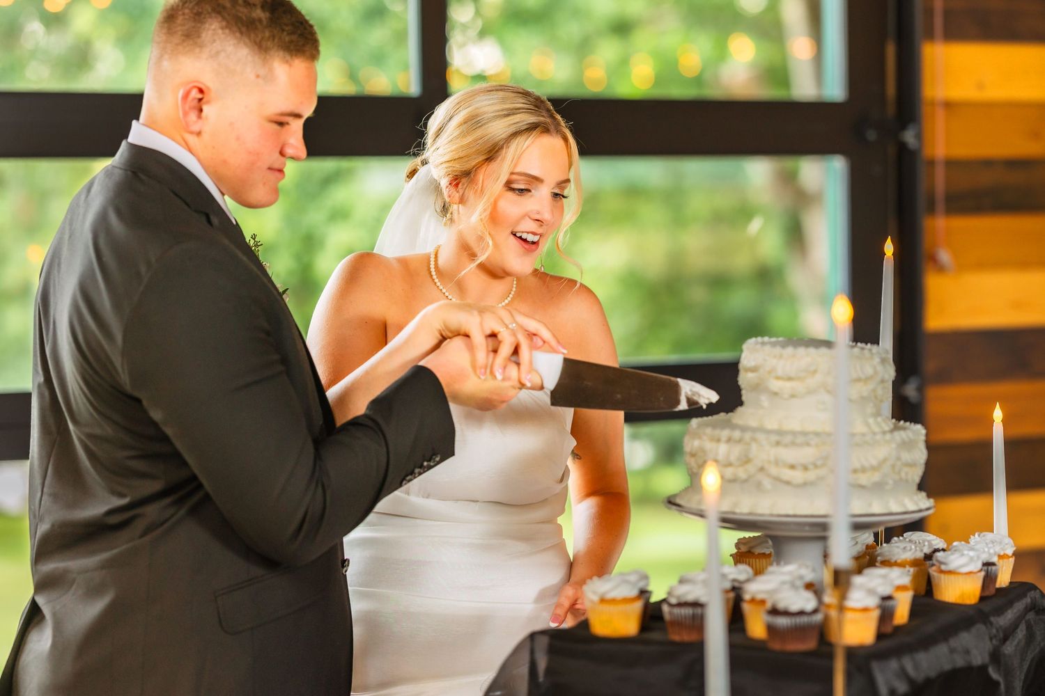 Couple shares joyful moments during their wedding celebration in a rustic venue.