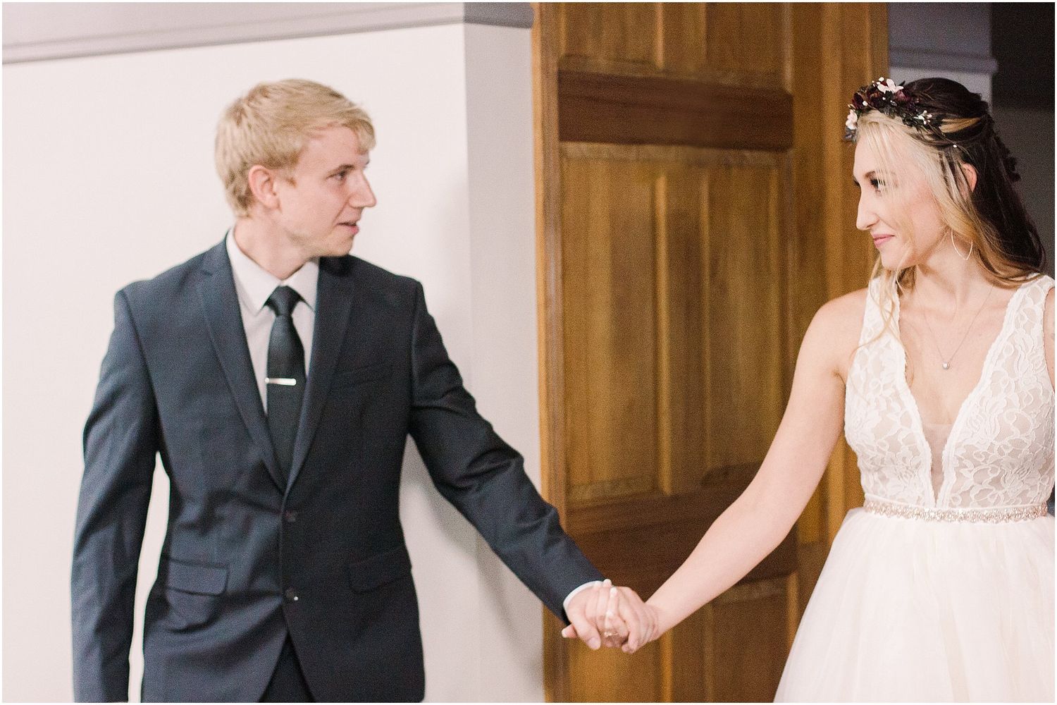 A couple reaches for each other's hands during their wedding first look moment.