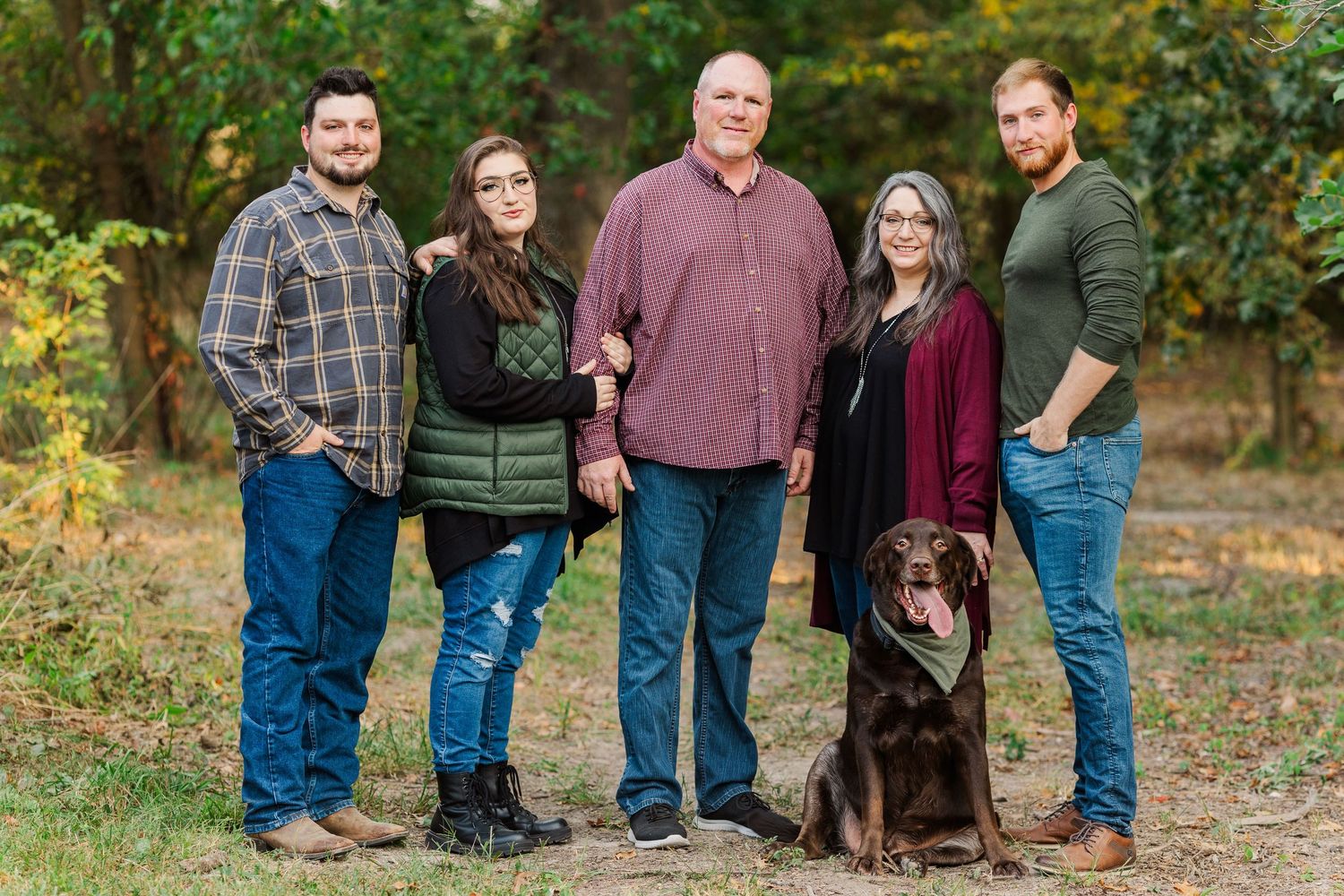 Extended family gathering outdoors for group portraits in casual attire during fall.