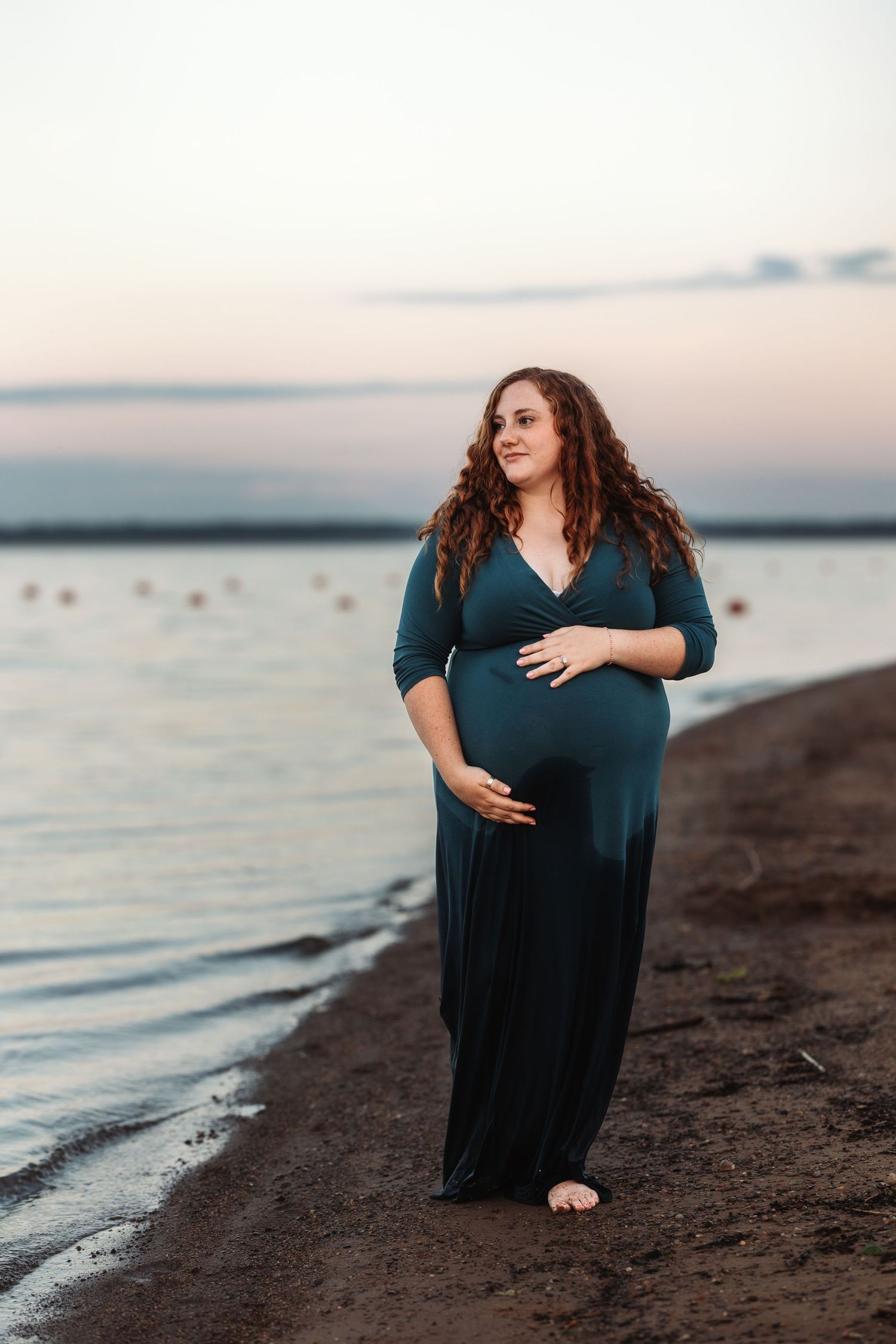 A maternity photo session at sunset captures silhouettes against a beach backdrop.