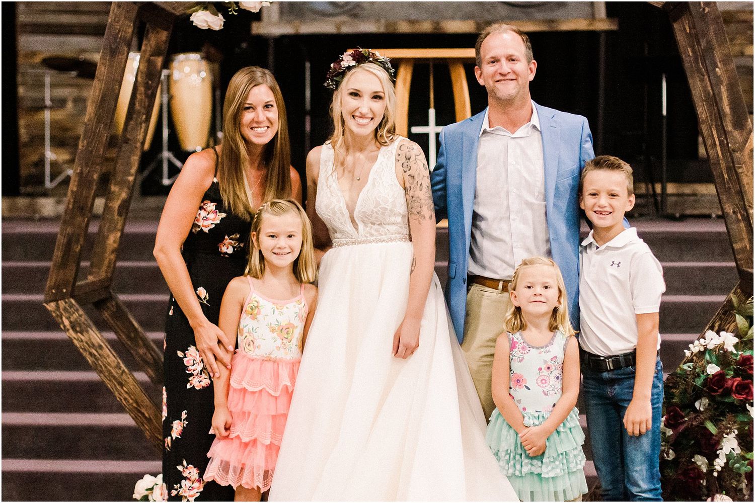 Family members gather on wooden steps for a wedding portrait.