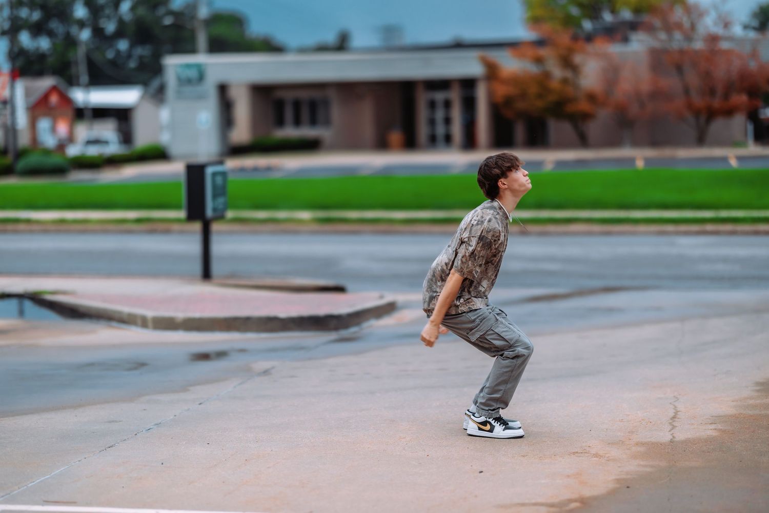 A skateboarder performs a sequence of trick moves on a concrete ramp at an outdoor skate park.