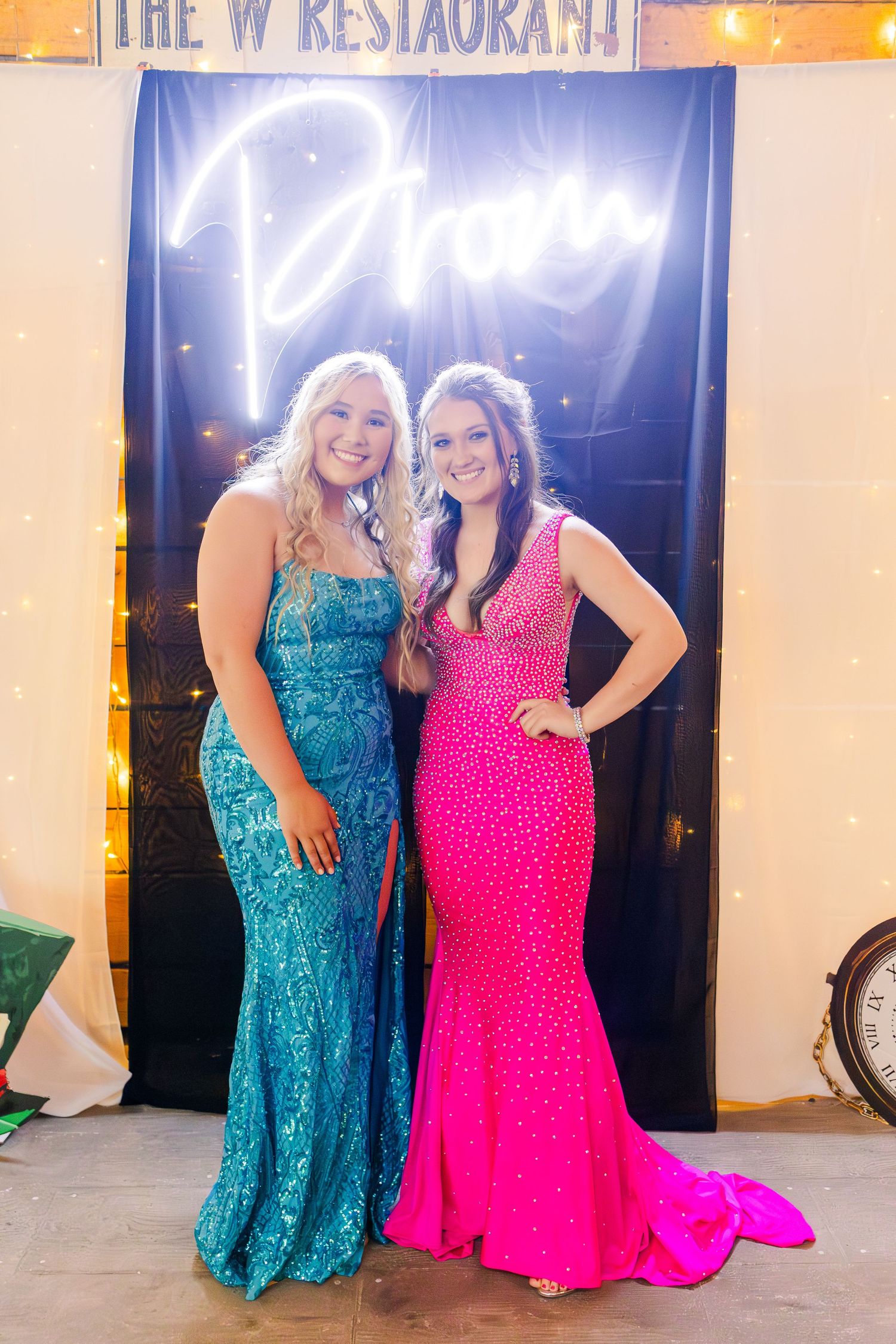 Pairs in bright turquoise and hot pink formal dresses pose at The W Restaurant.