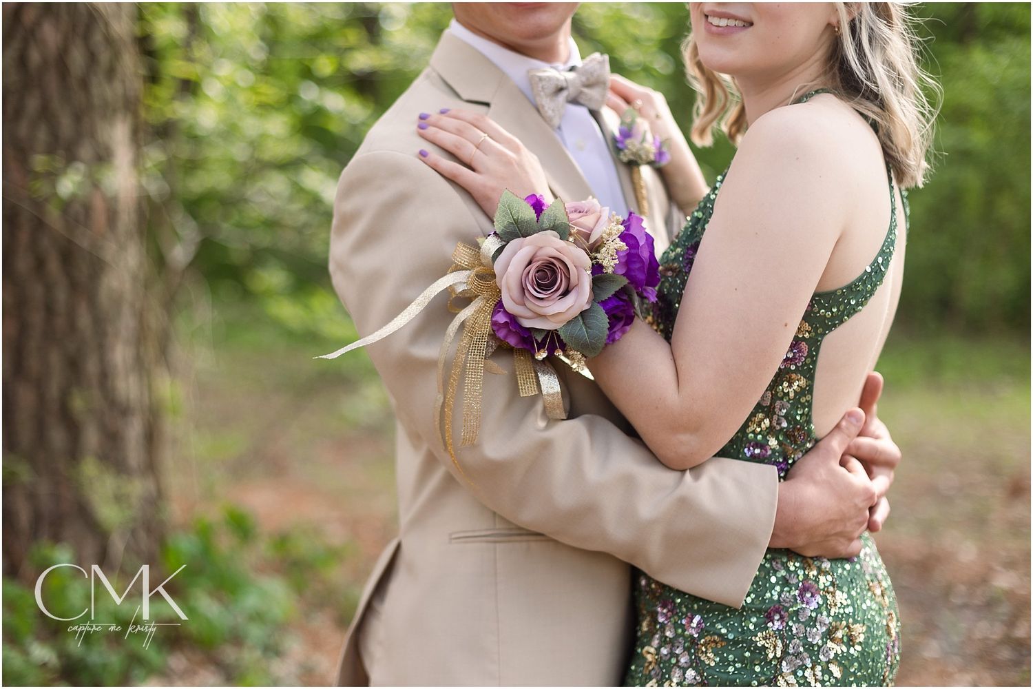 Detail shot of purple floral corsage and formal attire during a prom photoshoot.