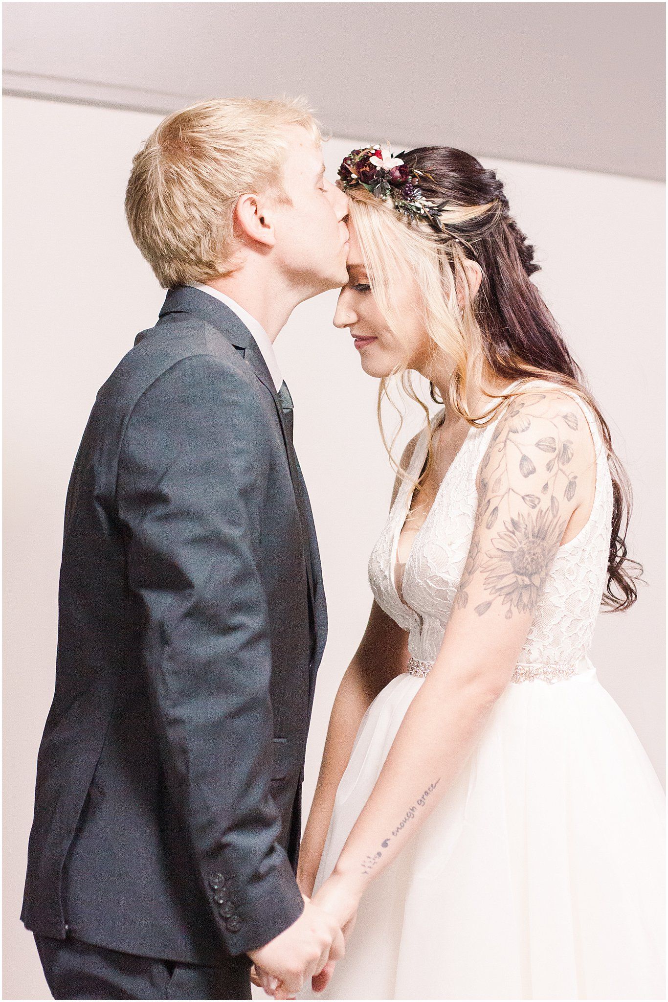 Intimate wedding moment with couple sharing a tender forehead touch.