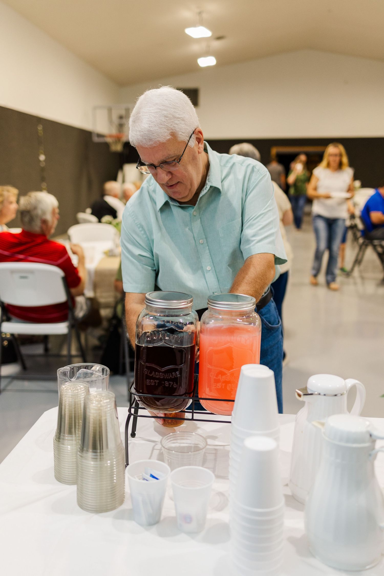 Drink station setup with dispensers and cups for serving beverages at an event.