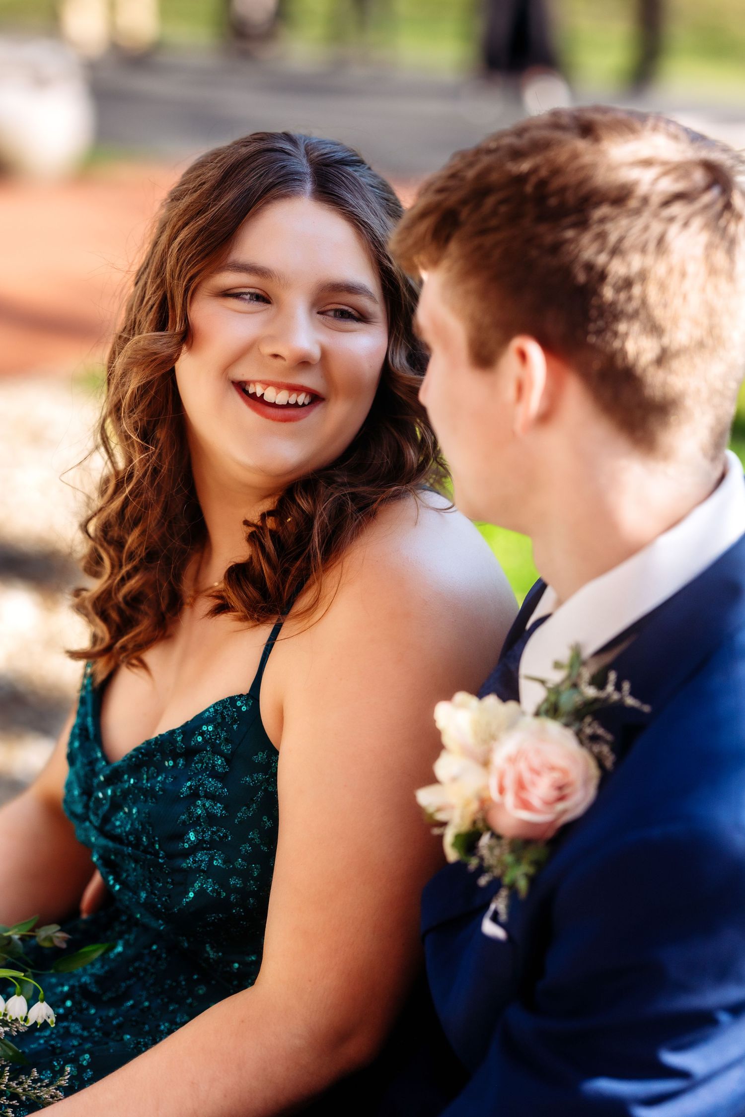 A romantic wedding couple in emerald green and navy blue share tender moments in a series of outdoor portraits.
