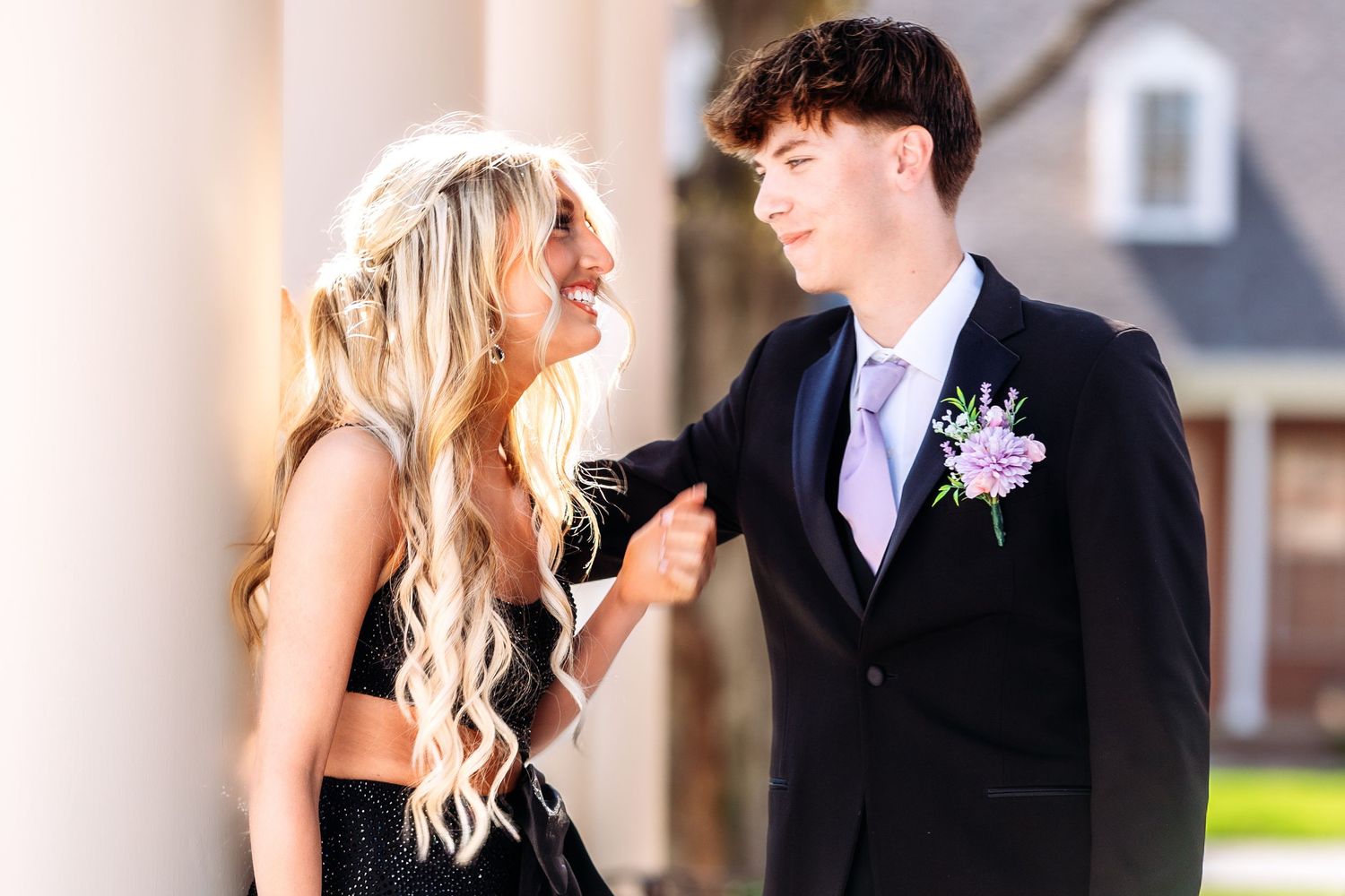 A couple in wedding attire share a romantic moment together during their outdoor wedding celebration.