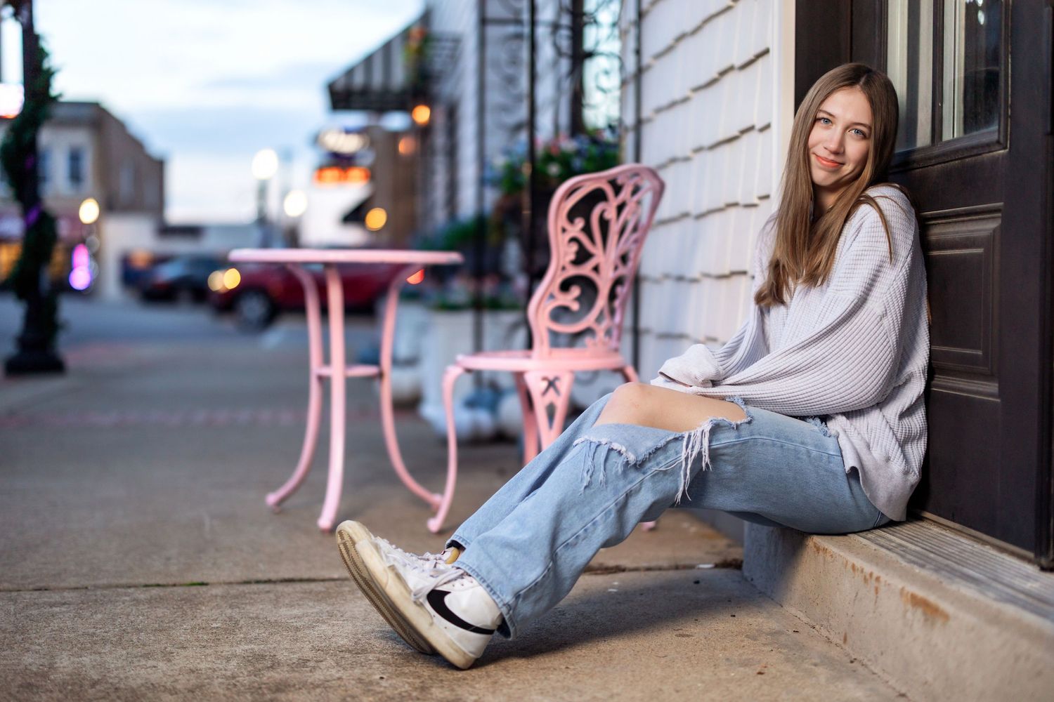Woman in casual attire posing against an urban backdrop in various seated positions.