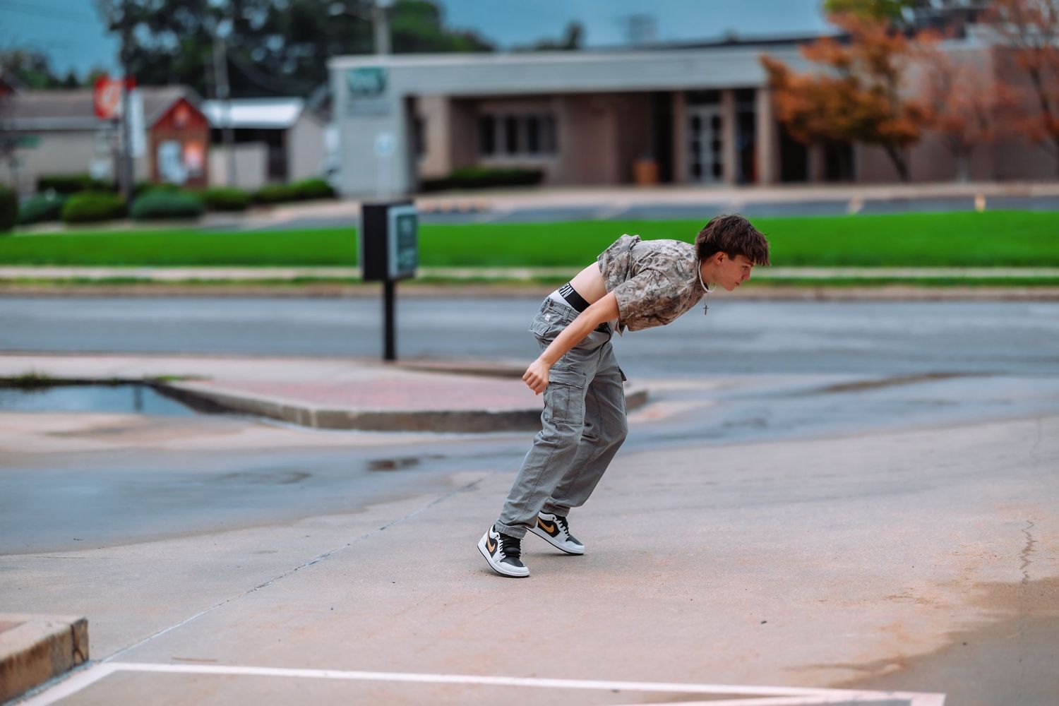 A skateboarder performs a trick sequence on a concrete ledge in an urban setting.