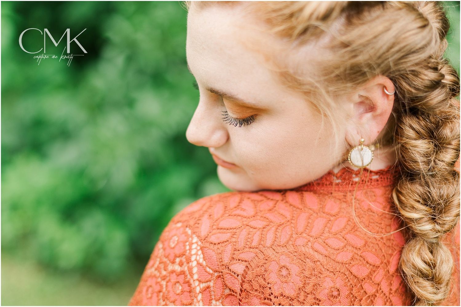Detailed side view showing intricate braid and coral lace dress details.