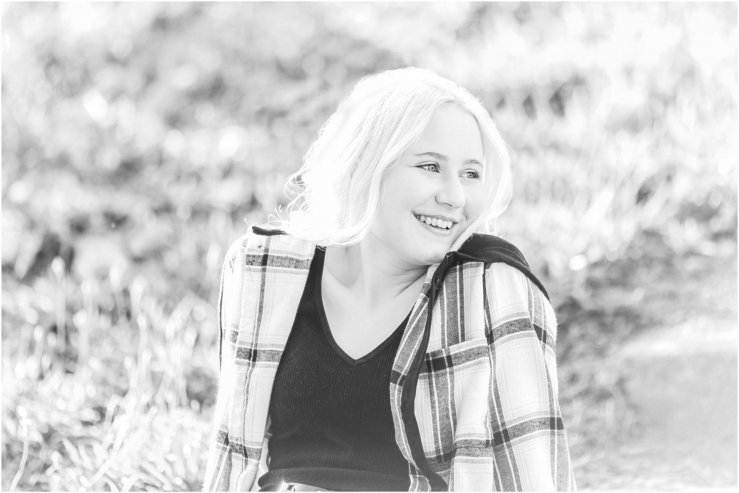 Blonde Hair Senior girl smiling back over her shoulder
