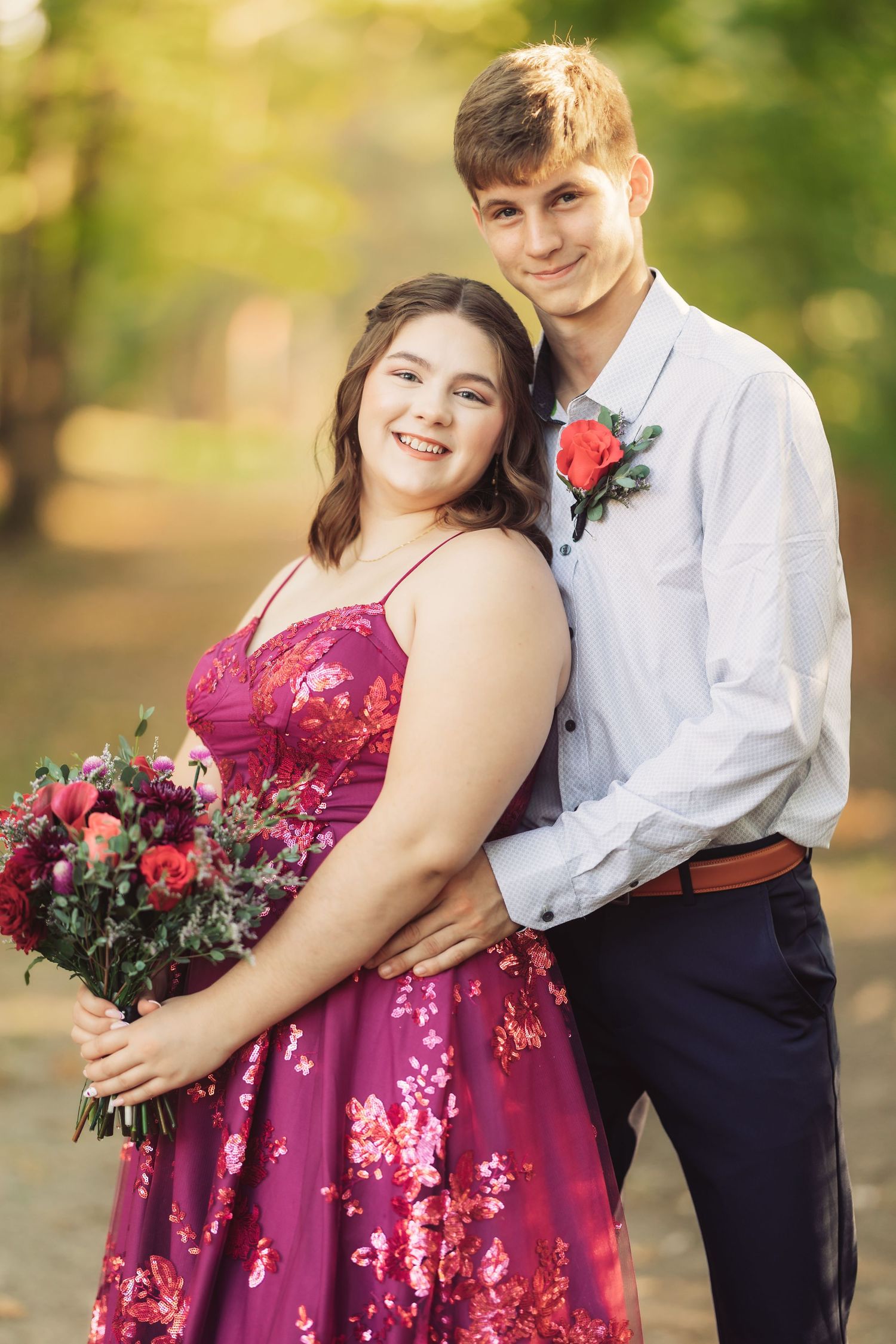 Formal couple's portraits featuring burgundy dress and white dress shirt in natural lighting.