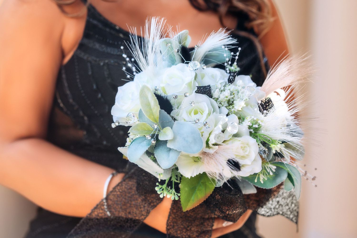 Bridesmaids holding elegant white and blue floral bouquets with delicate baby's breath accents.