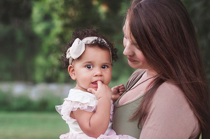 Candid moment of parent and child sharing tender interaction outdoors.