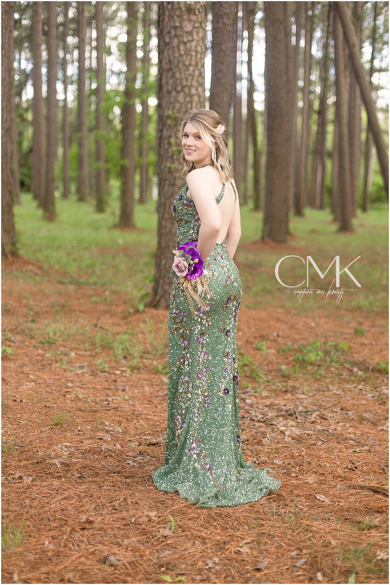 Elegant green sequined gown photographed in a serene forest setting.