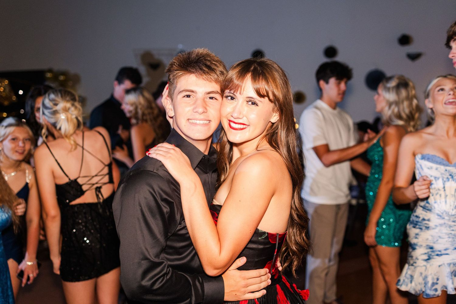 Guests enjoying themselves on a dance floor at an evening celebration.