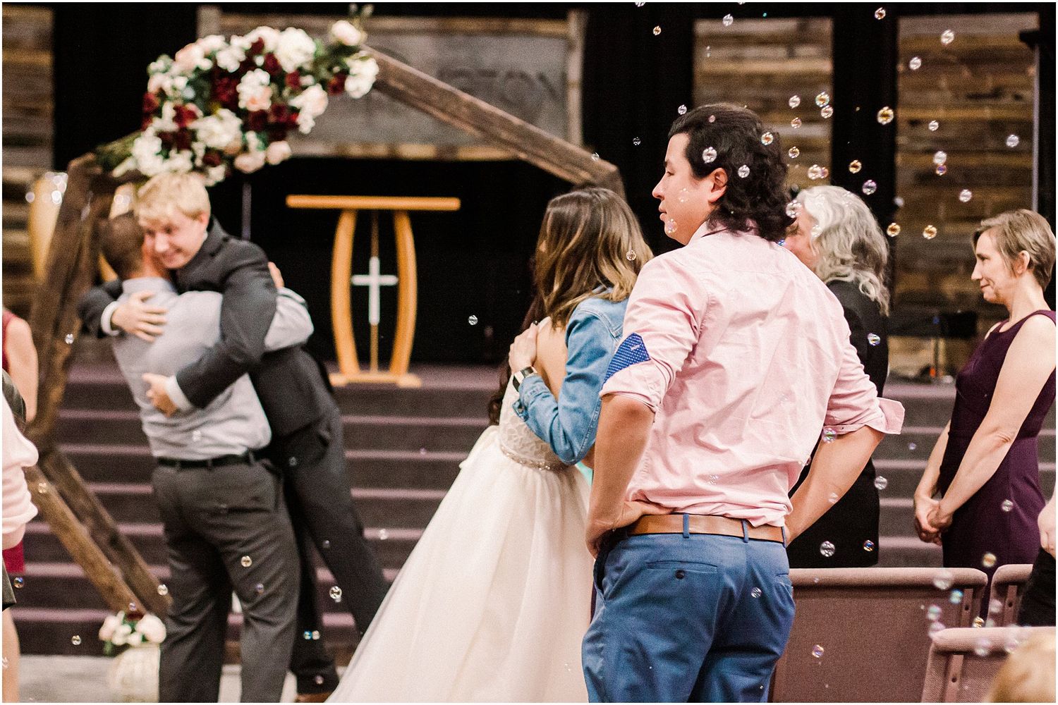 Candid moment of wedding guests celebrating and dancing at the reception.