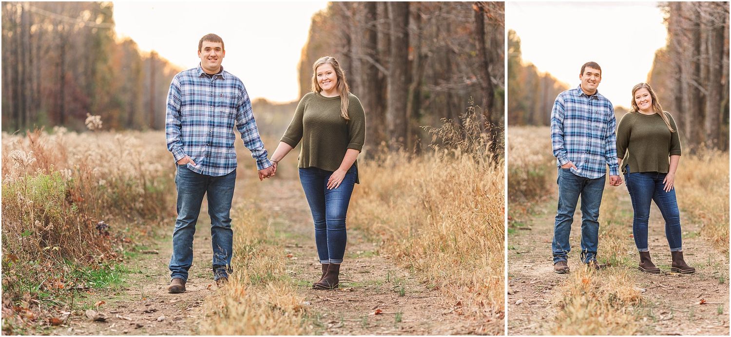 Romantic couple walks hand in hand through tall grass at sunset in wooded area.