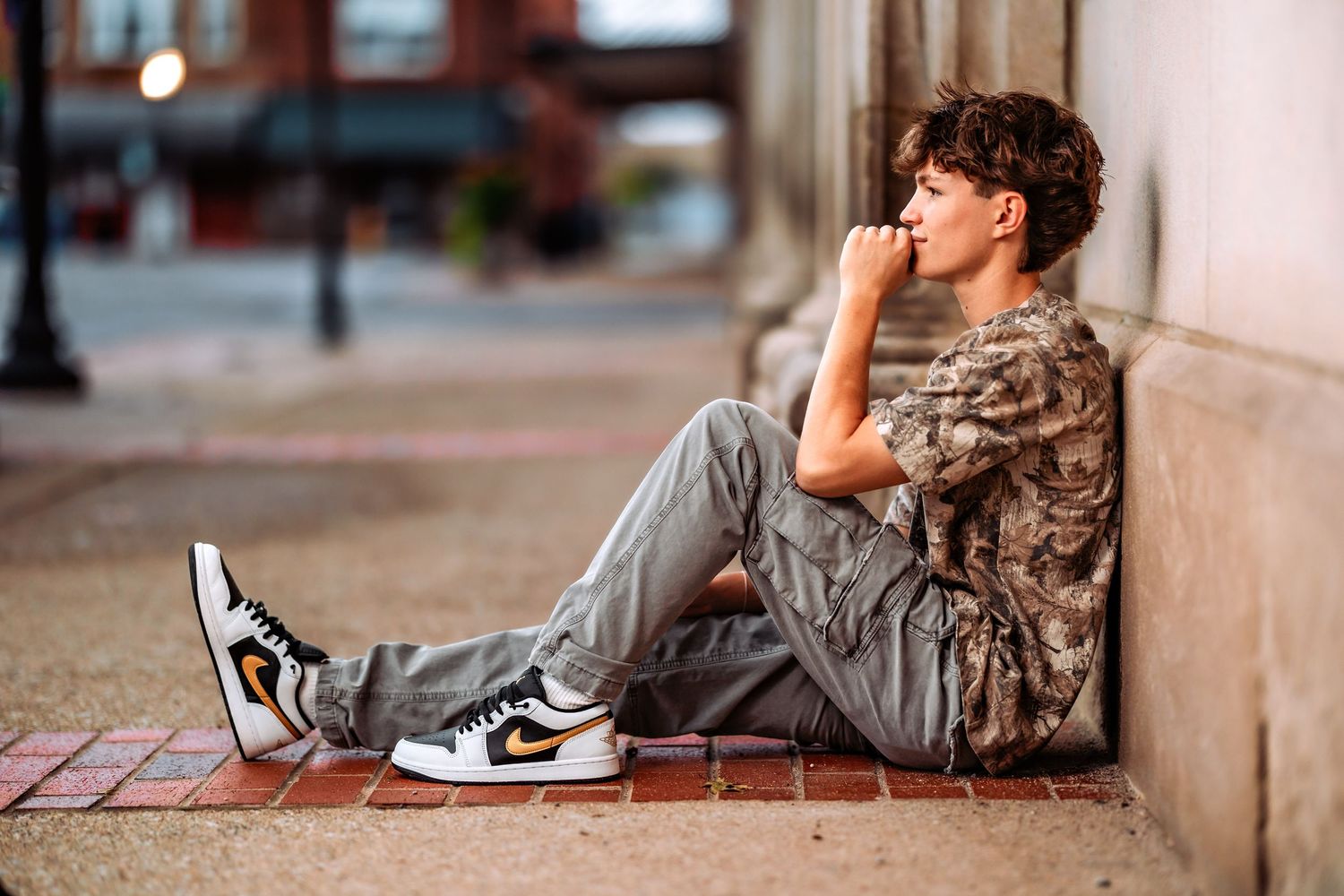 A series of connected images showing a young person in casual wear lounging against a wall with a skateboard nearby.