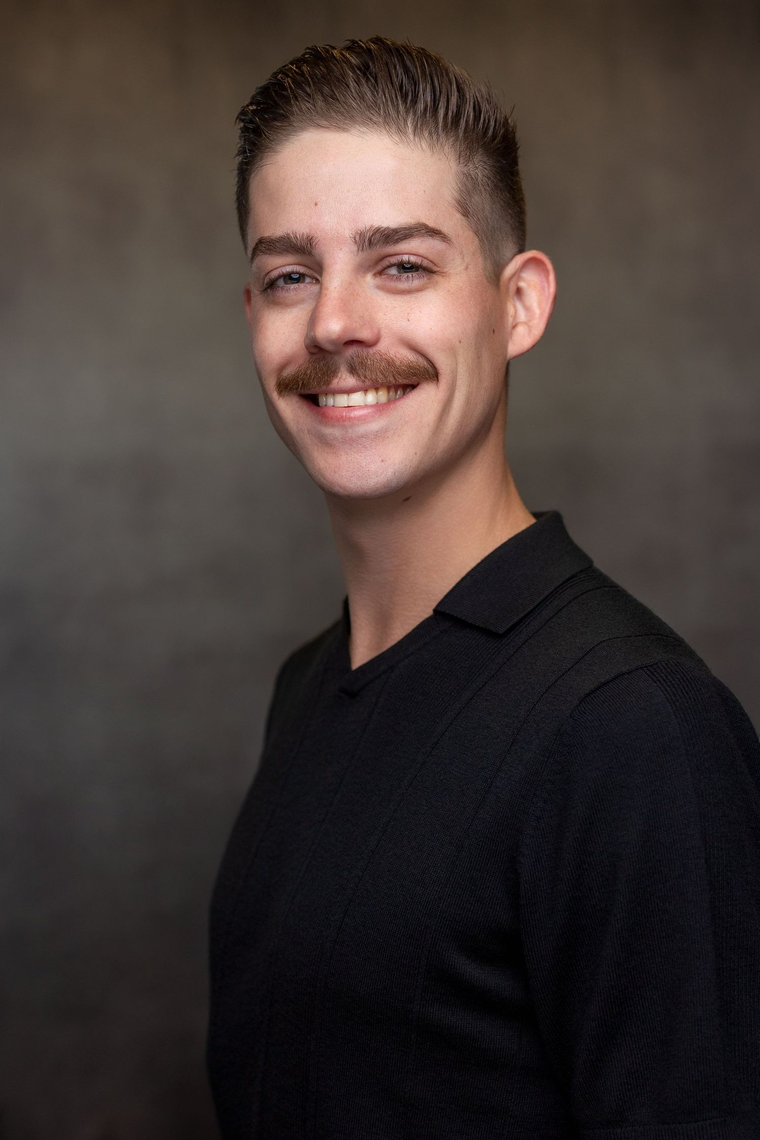 Series of professional headshots showing person in black shirt with short dark hair against gray backdrop.