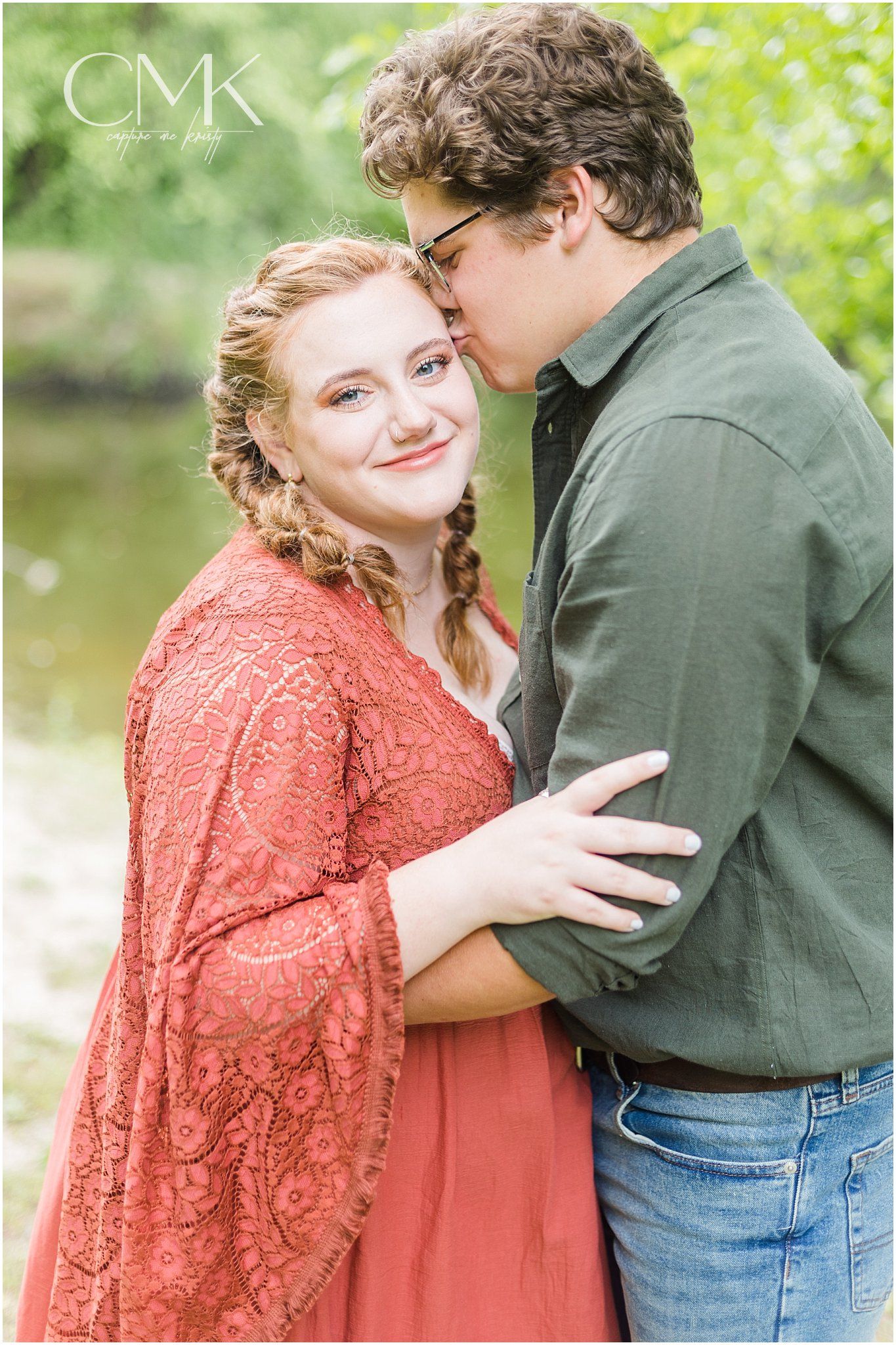 A sweet romantic moment between a couple during their outdoor photoshoot in nature.