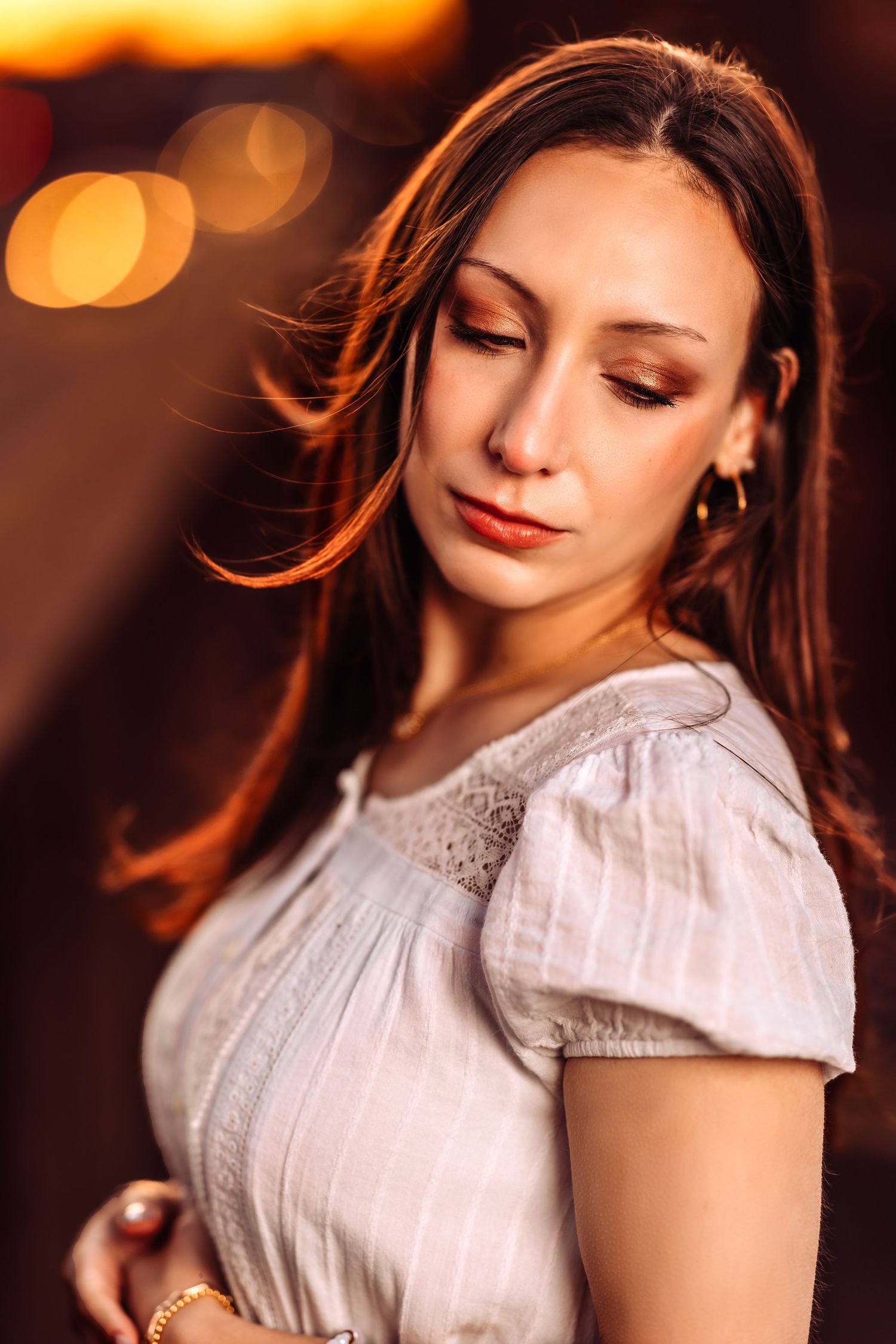 Romantic evening portraits with warm bokeh lighting and delicate white lace details.