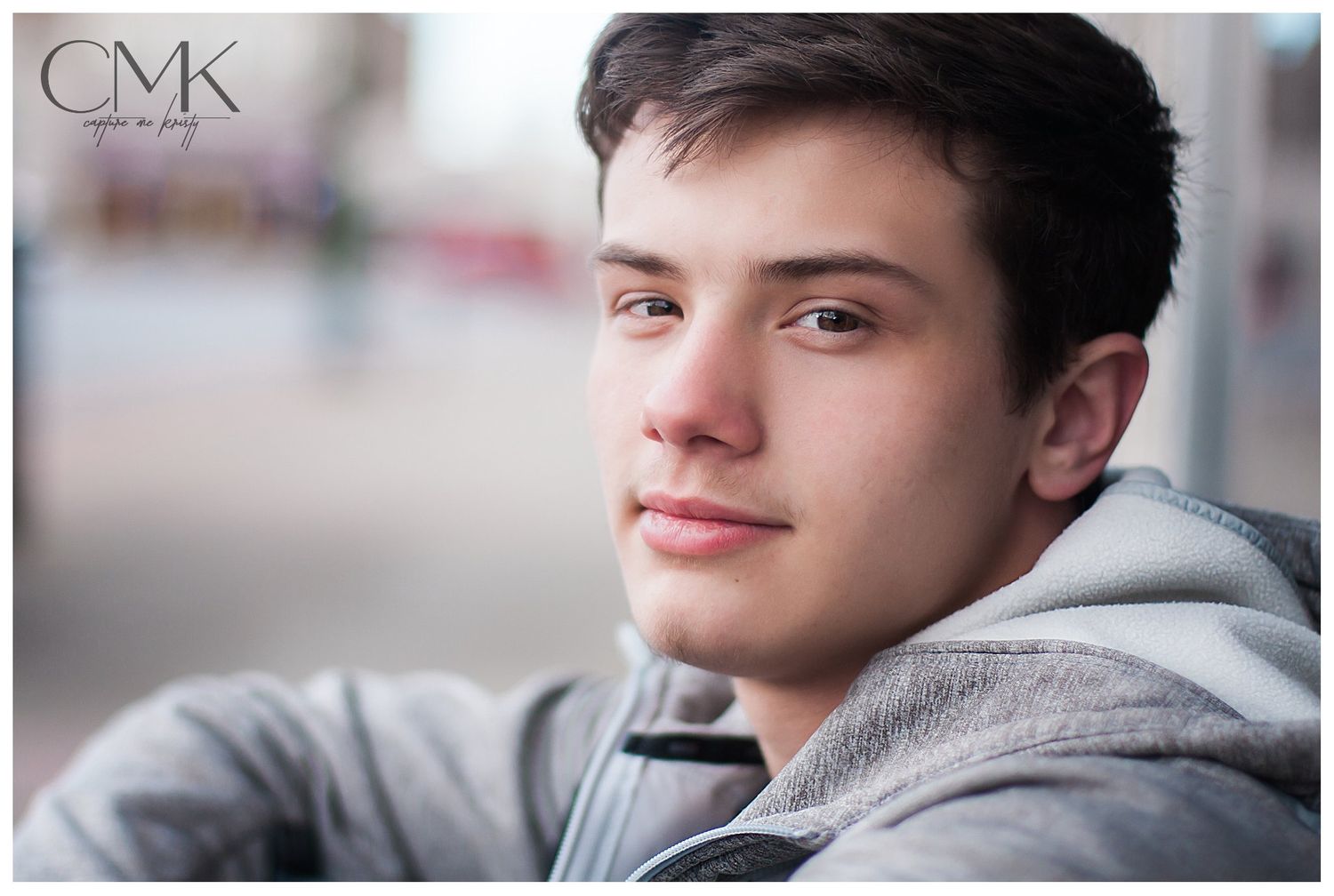 Senior Boy sitting against wall in urban setting, Capture Me Kristy, Benton Illinois