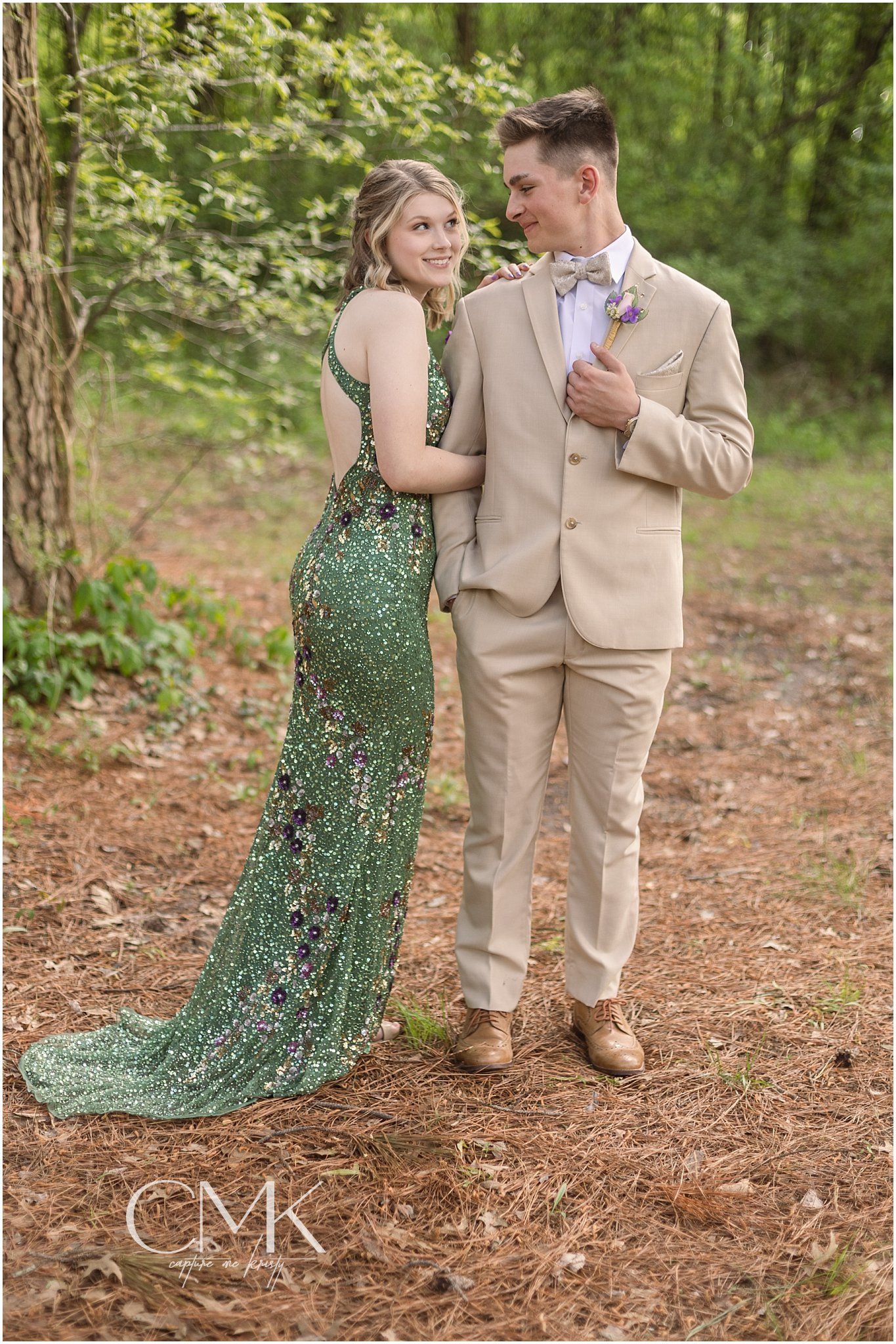 A formal photo shoot in the woods featuring coordinated formal wear and natural lighting.