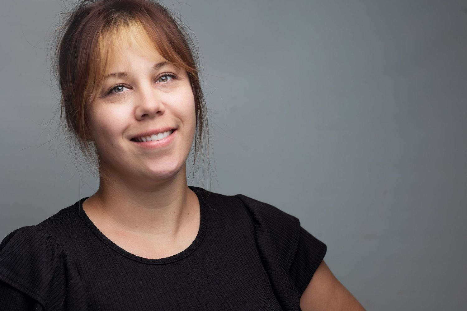 A collage of headshots showing someone in a black top against a gray background smiling warmly at the camera.