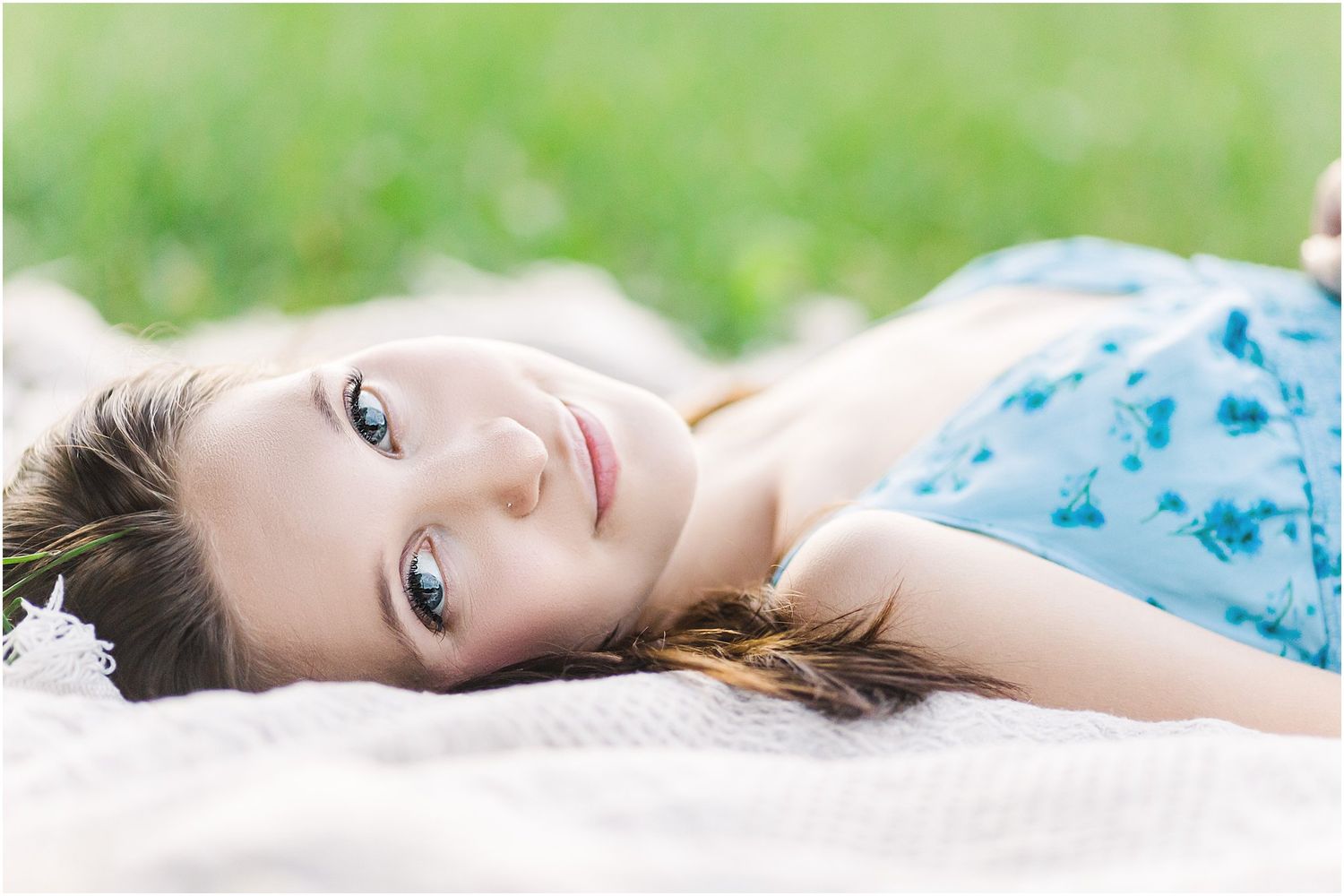 Soft portrait photo with natural lighting and blue floral dress.