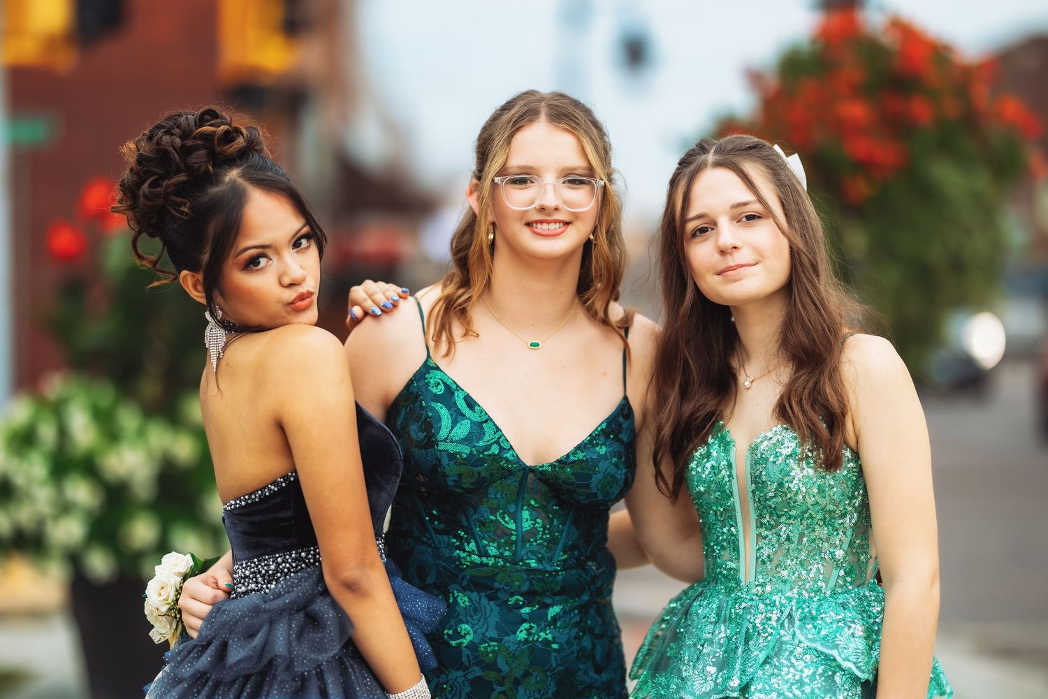Group photo of friends in coordinated blue and green formal attire.