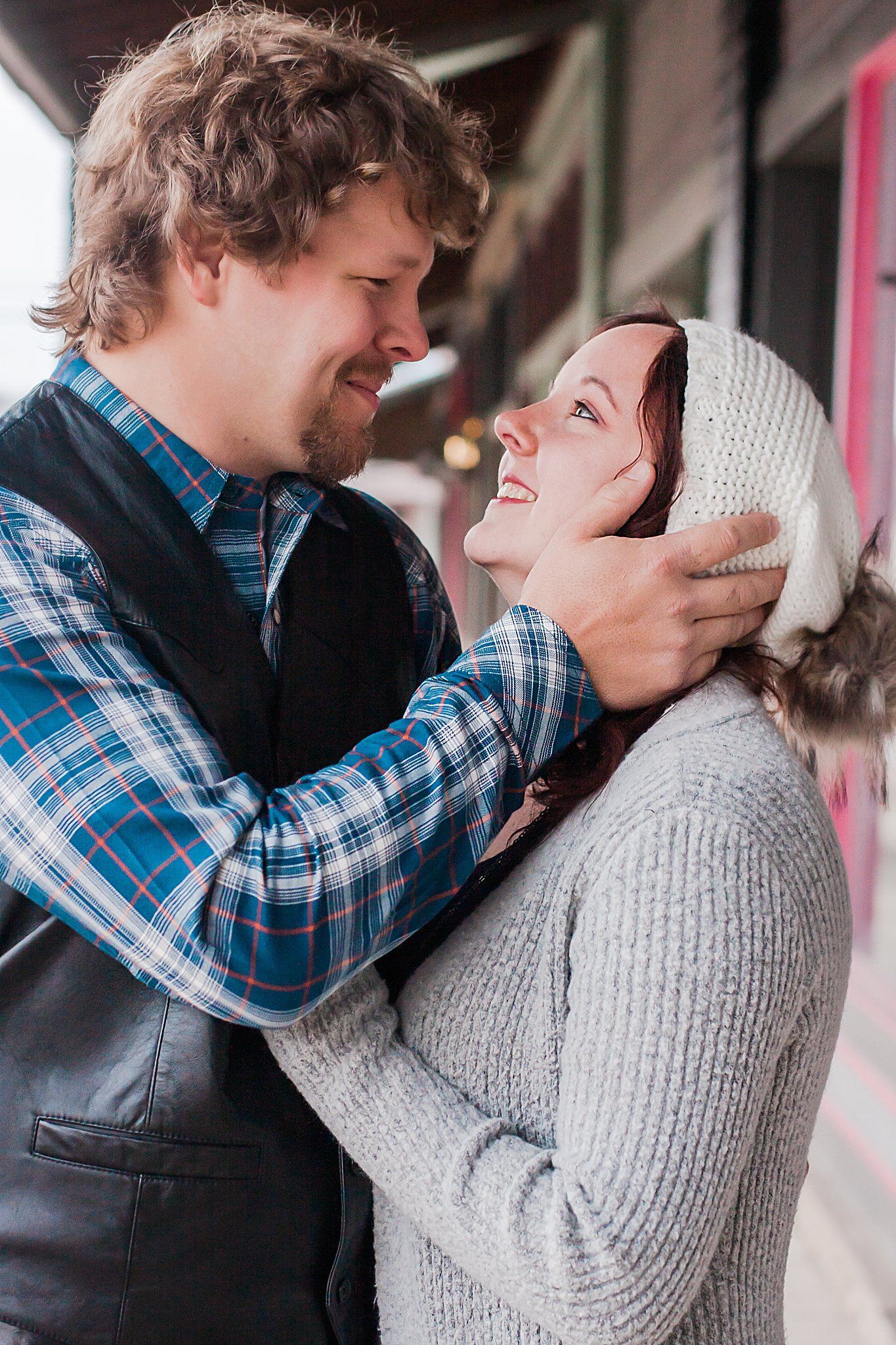 couple gazes into each other's eyes while man holds the side of head